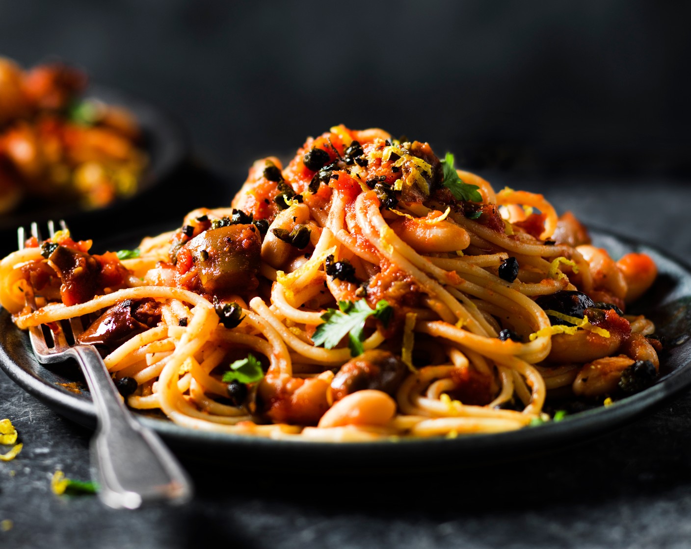 step 4 Drain the pasta into the aubergine sauce using tongs. Spoon into bowls and top with the crispy capers.