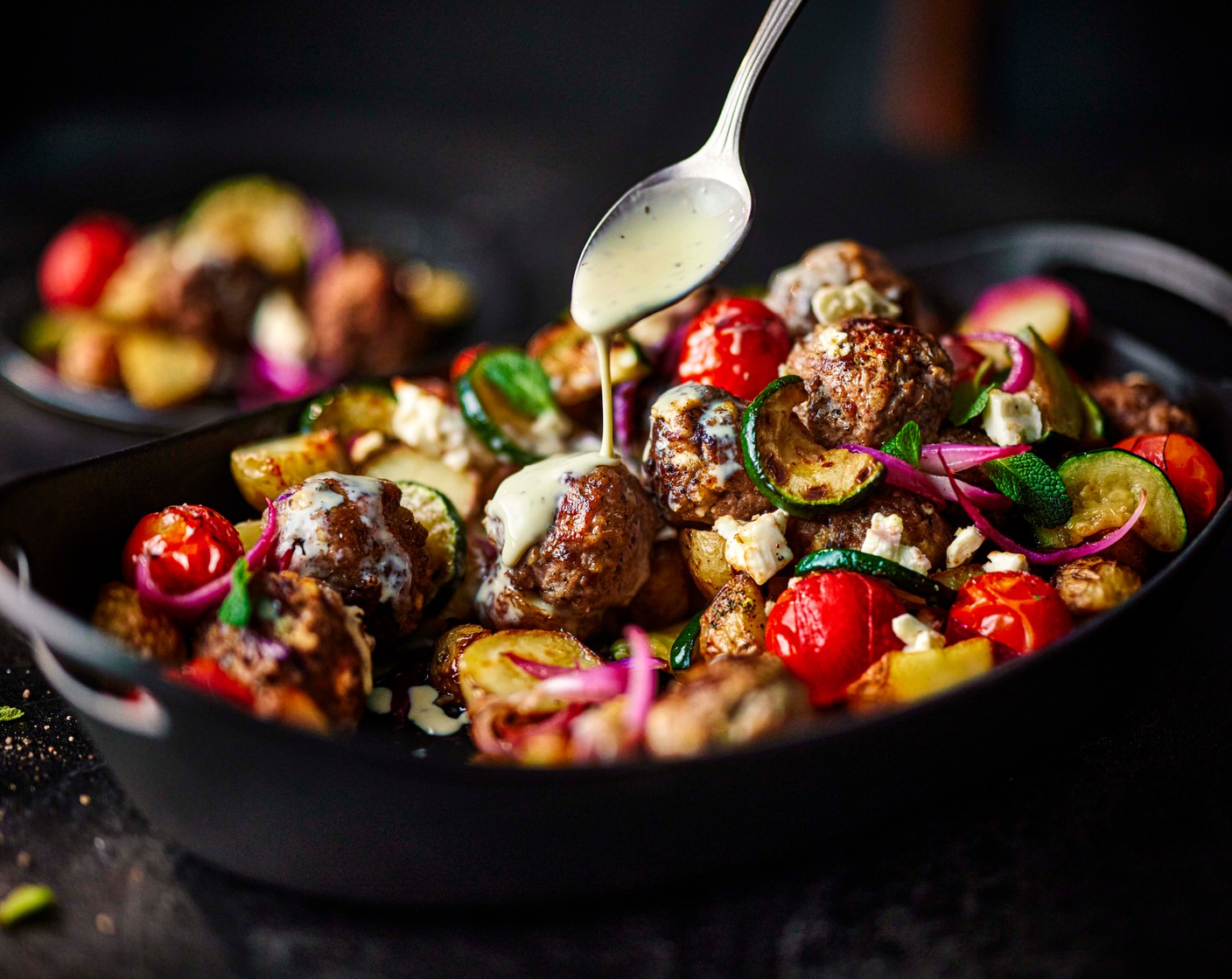 step 8 Once the traybake is cooked, drizzle the minty yogurt sauce over the traybake and serve immediately, with toasted pitta if you like.