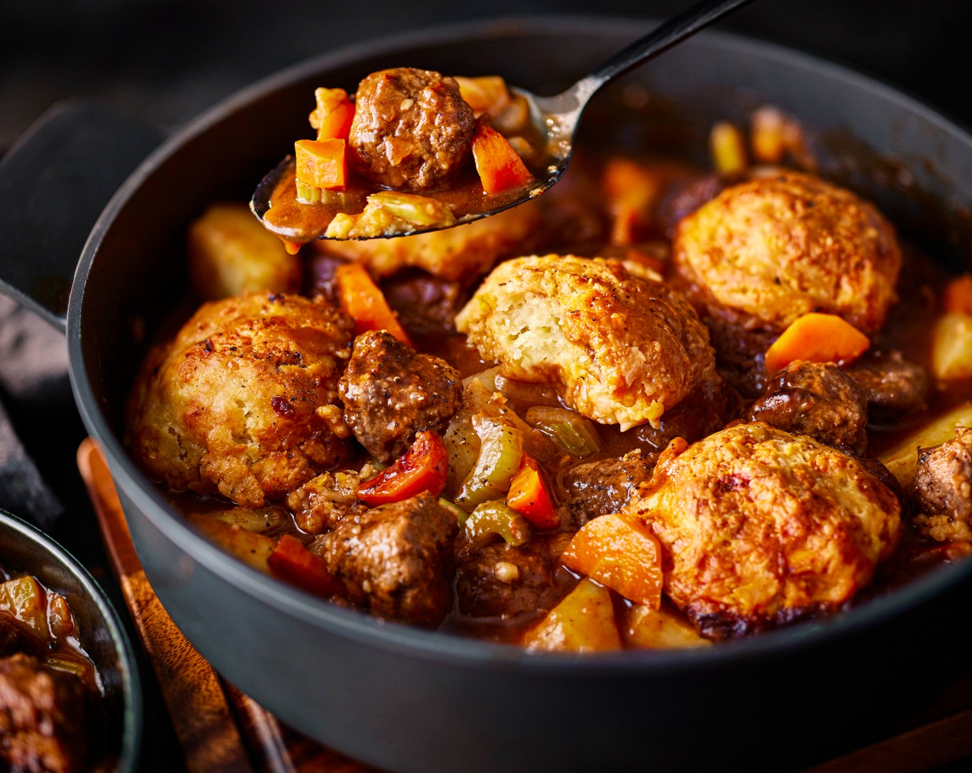 step 6 Arrange the dumplings on top of the stew and top with the remaining cheddar (50 g). Pop into the oven and cook for 25-30 minutes, until golden brown.