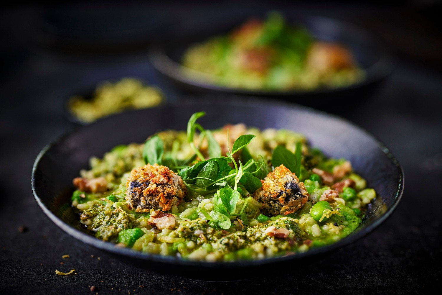 Risotto primavera with peas, broad beans, pesto and crispy black pudding