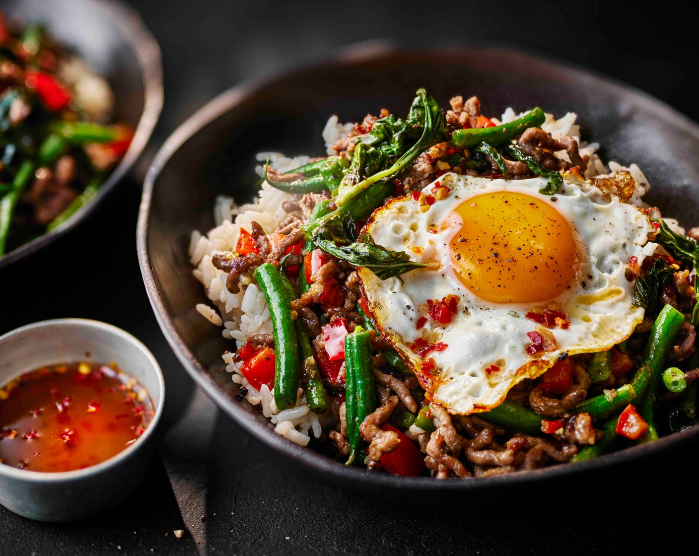 step 5 Spoon the rice into bowls and top with the Thai basil beef and fried egg.