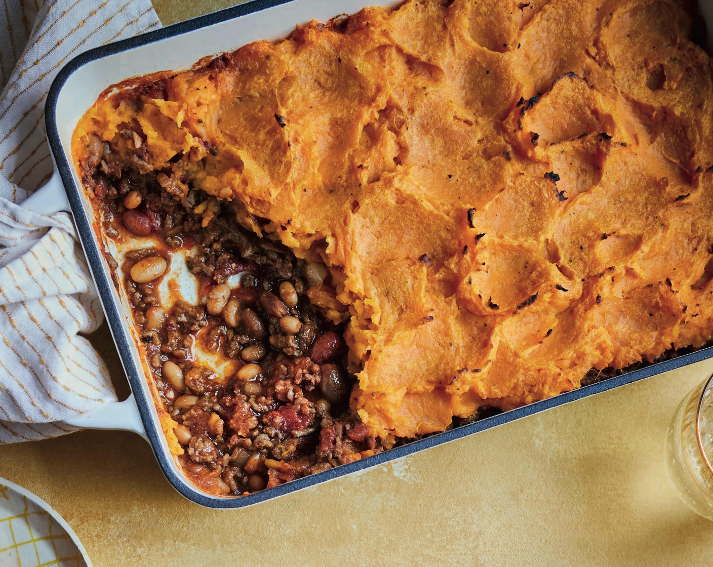 step 5 Preheat the grill to high. Tip the beef and bean mixture into a 1.5 litre ovenproof dish and cover with the sweet potato, then grill until golden.