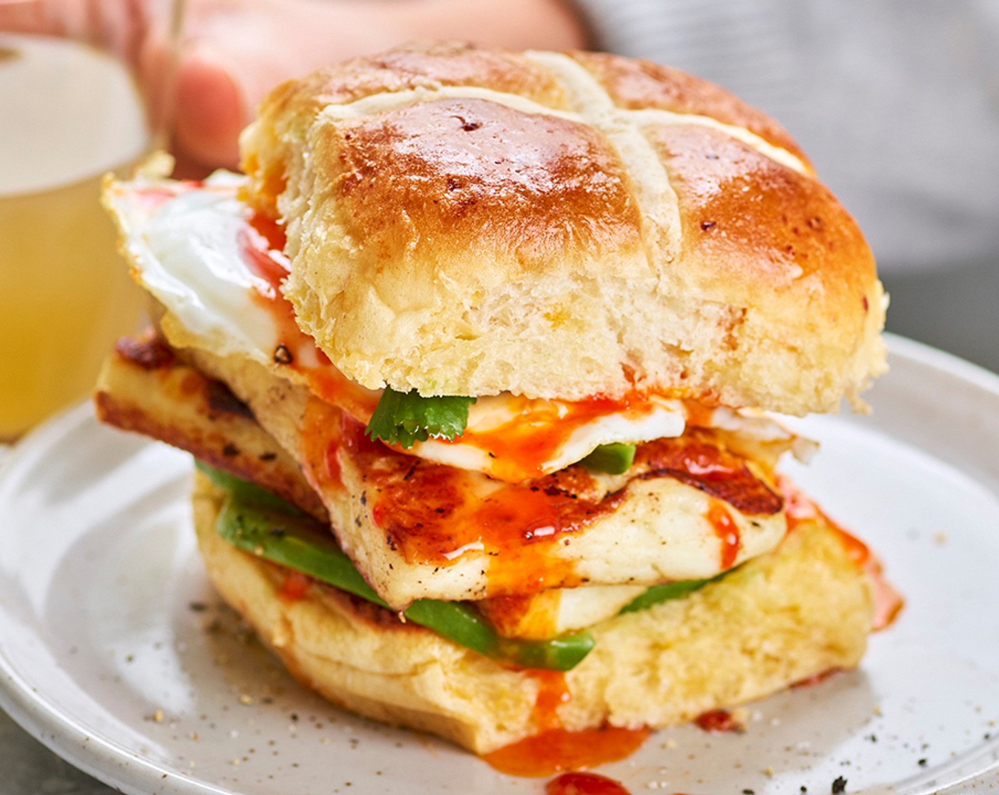 step 4 To assemble, fill the buns with the sweet chilli halloumi, egg and avocado, adding an extra drizzle of chilli sauce (to taste), if you like.