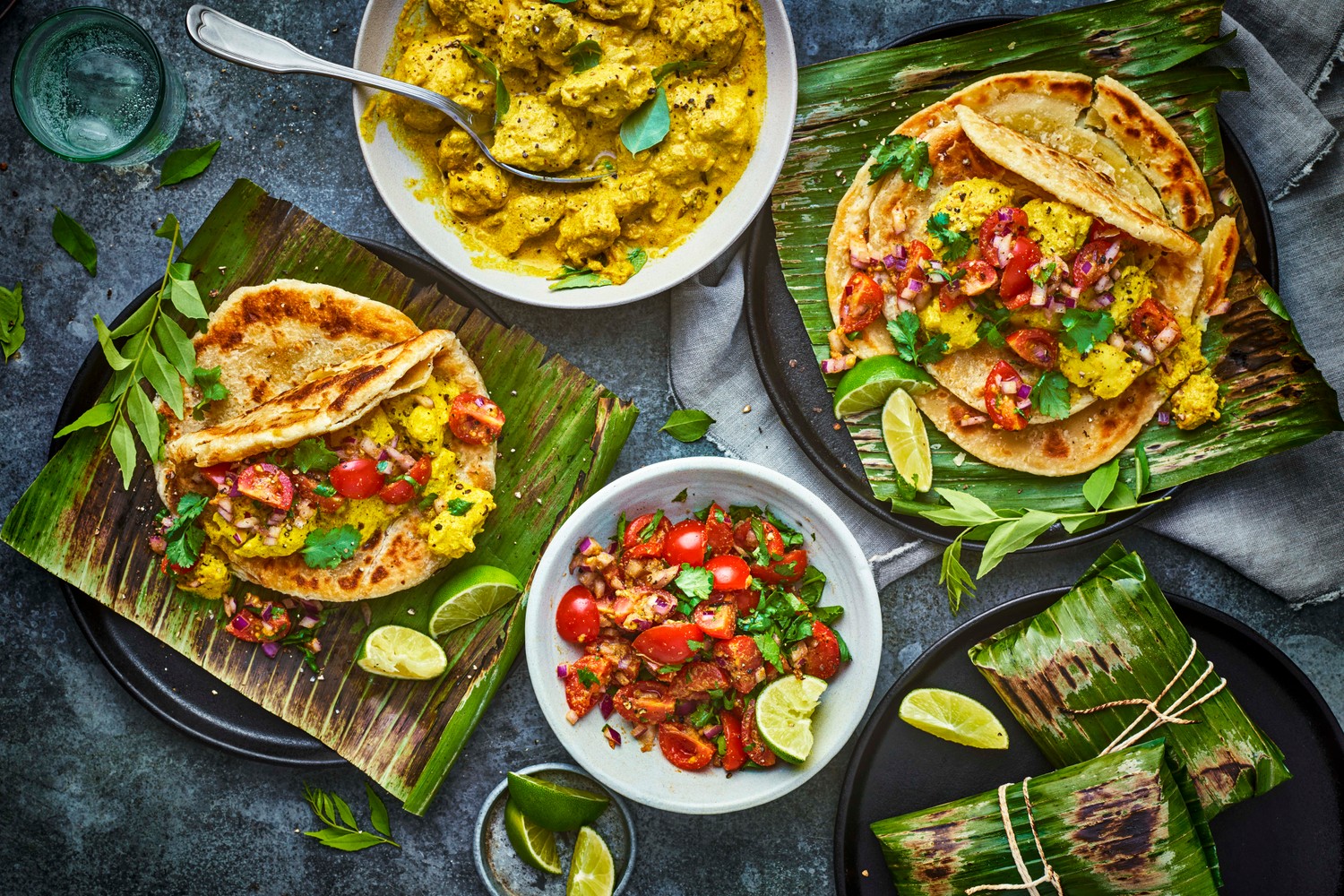 Chicken kizhi wrapped in banana leaves, with parathas and kachumber salad