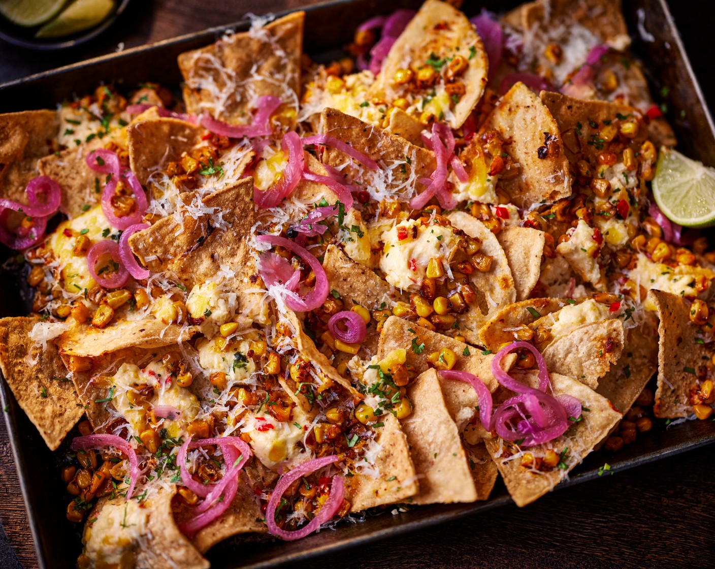 step 3 Once baked, top with the finely grated pecorino (15 g), coriander (10 g) and pickled red onions (1 tbsp). Serve with the remaining lime (1/2), cut into wedges, on the side.