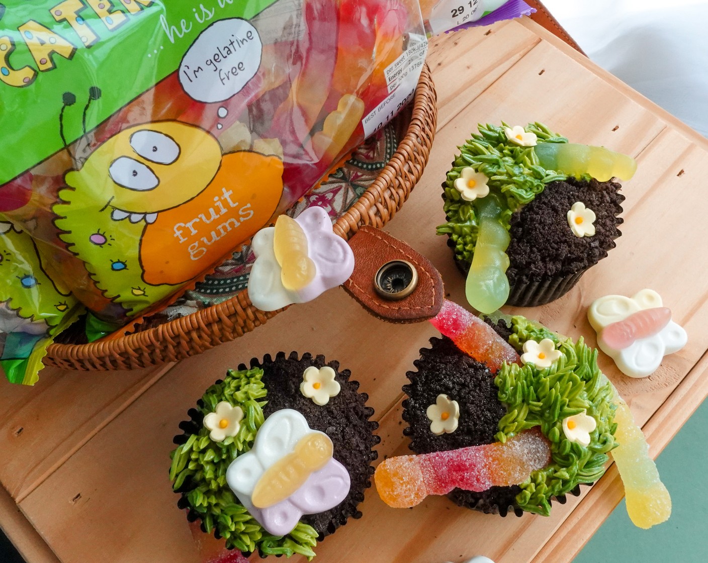 step 13 Adorn the finished cupcakes with Colin the Caterpillar sweets (1 pack) and chocolate biscuit crumbs (to taste).