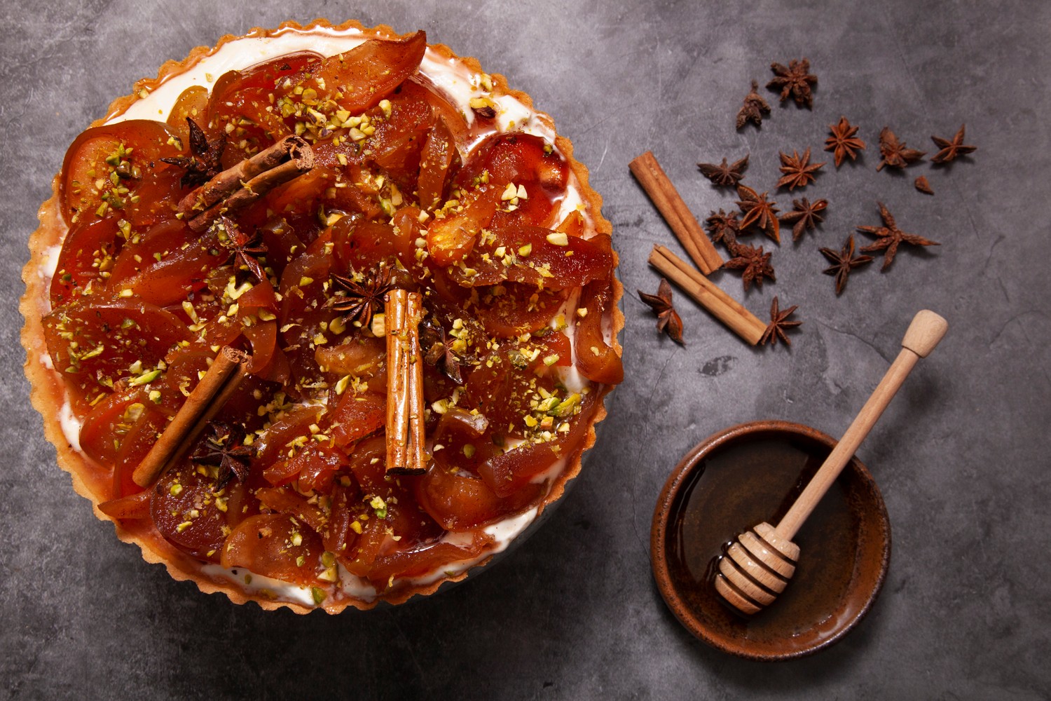 Spiced candied apple tart with lemon yogurt cream and pistachios