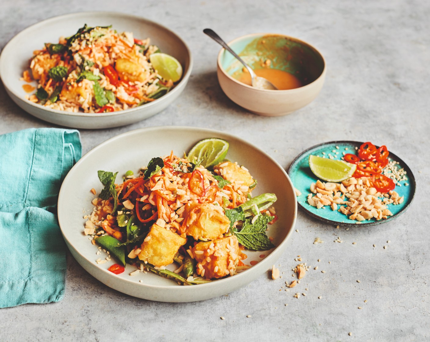 step 6 Drizzle over the dressing and mix gently until everything is coated. Divide between serving dishes and sprinkle over the sesame seeds (4 tbsp) along with the remaining chillies (1), peanuts and mint. Squeeze a lime wedge (1) over each dish to serve.