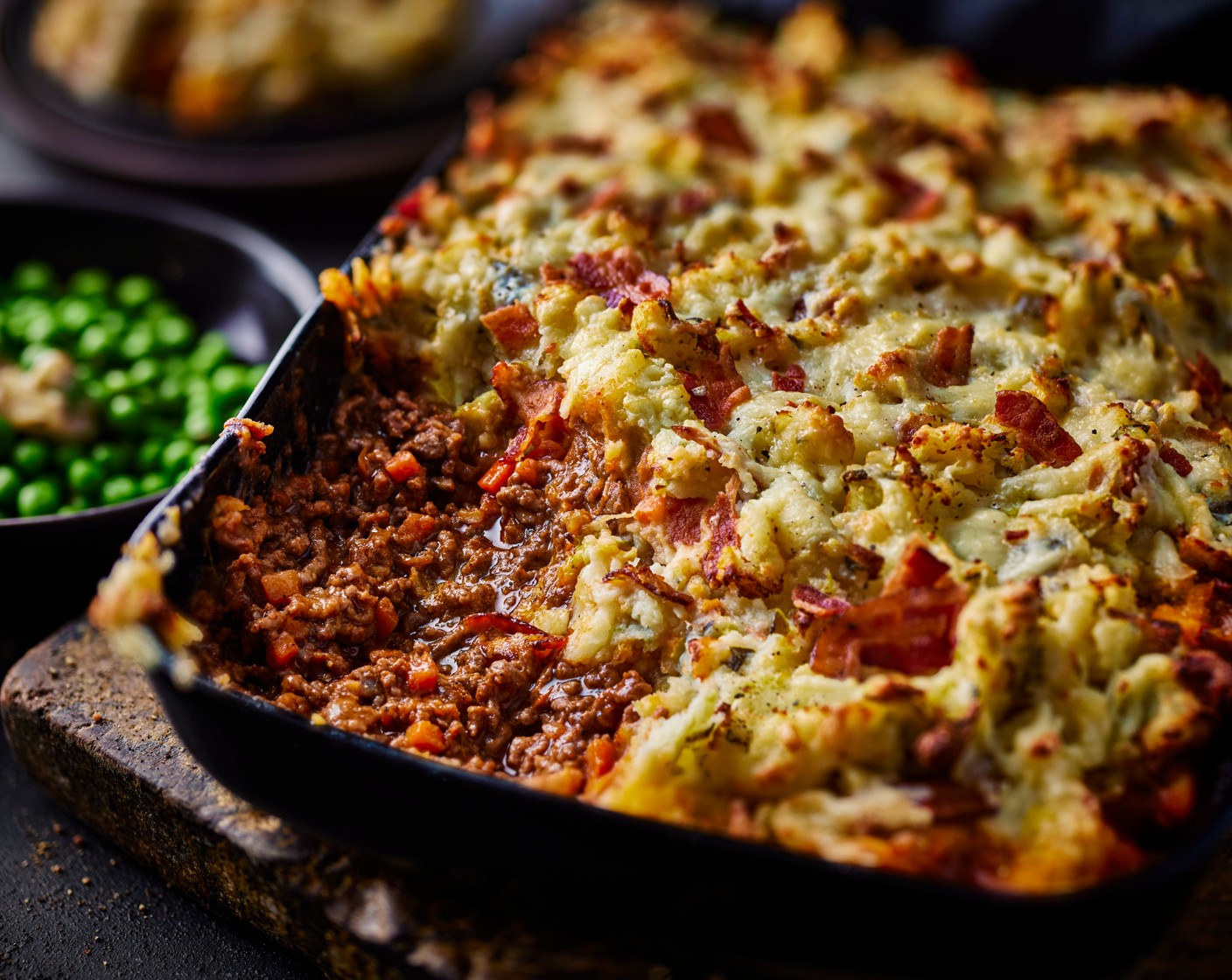 step 4 Meanwhile, bring a saucepan filled with hot water to boil. Add the peas (200 g) and cook for 2 minutes and then drain. Return to the pan and mix with the garlic and herb butter (2 pieces). Serve alongside the pie.