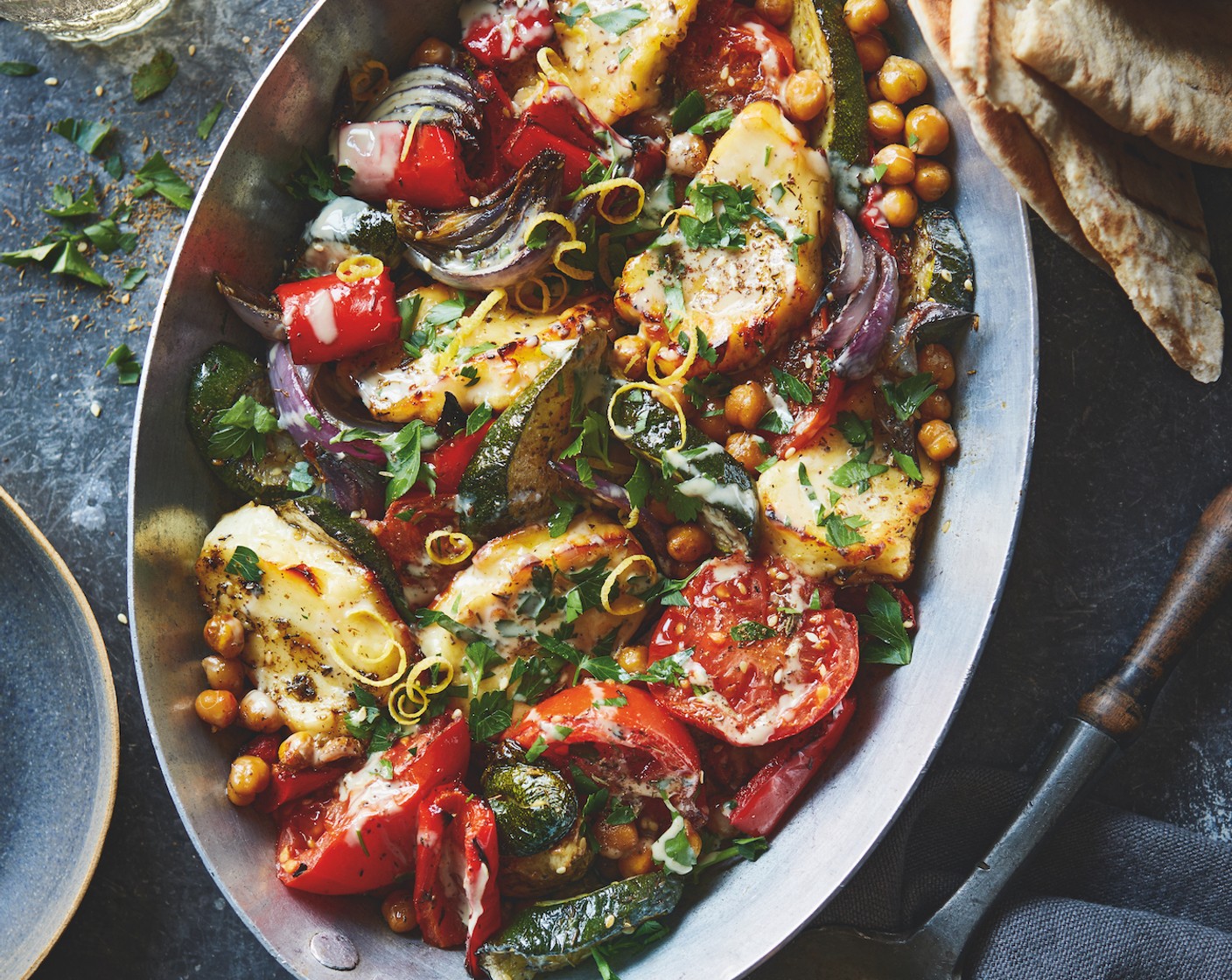 step 5 Grate over the lemon zest (1) and squeeze over the juice. Sprinkle over the remaining za'atar (2 tbsp), drizzle with the tahini (2 tbsp) and add a scattering of fresh parsley (25 g). Serve with flatbread (4).