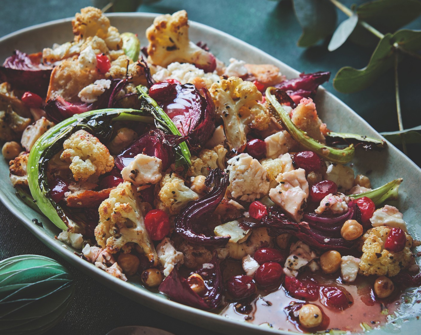 step 2 Reduce the oven temperature to 200°C/180°C fan. Toss the cranberries (100 g), bread (100 g), hazelnuts (50 g) and vinegar (2 tsp) into the roasting tin (not forgetting the remaining cauliflower leaves), taking care not to break up the feta (200 g) too much. Season, drizzle with a little more olive oil and return to the oven for 10-15 minutes, until the cauliflower and bread look charred, the cranberries look jammy and the feta is golden. Serve with a drizzle of honey (2 tsp).