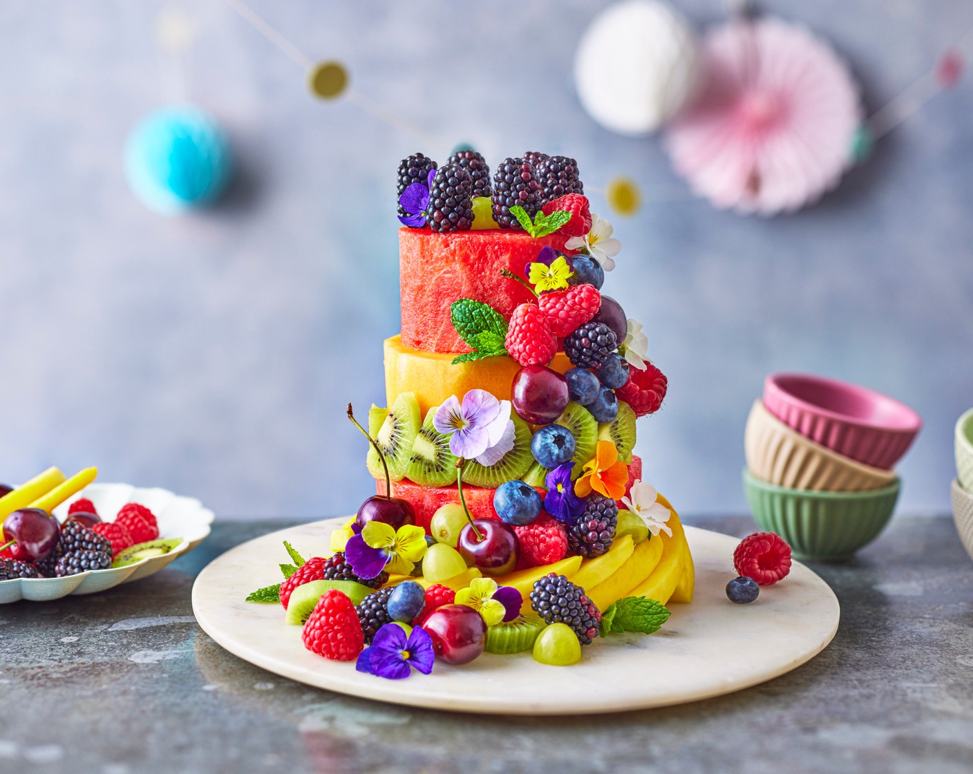 step 5 Decorate using mango (1 pack), kiwi (as needed), grapes (as needed), raspberries (as needed), blueberries (as needed), mint (as needed), flowers (as needed), or any other fruit your child loves. Canned pineapple rings make a fun trim for the outside, and blackberries make a very grand crown for the top. You could also take the melon remnants or some fresh pineapple and use cutters to form shapes, letters or numbers. Avoid anything that browns quickly: banana, apple and pear are no-gos.

(All age suitability recommendations and recipes are only guides, please alter as appropriate to suit your baby’s weaning journey)