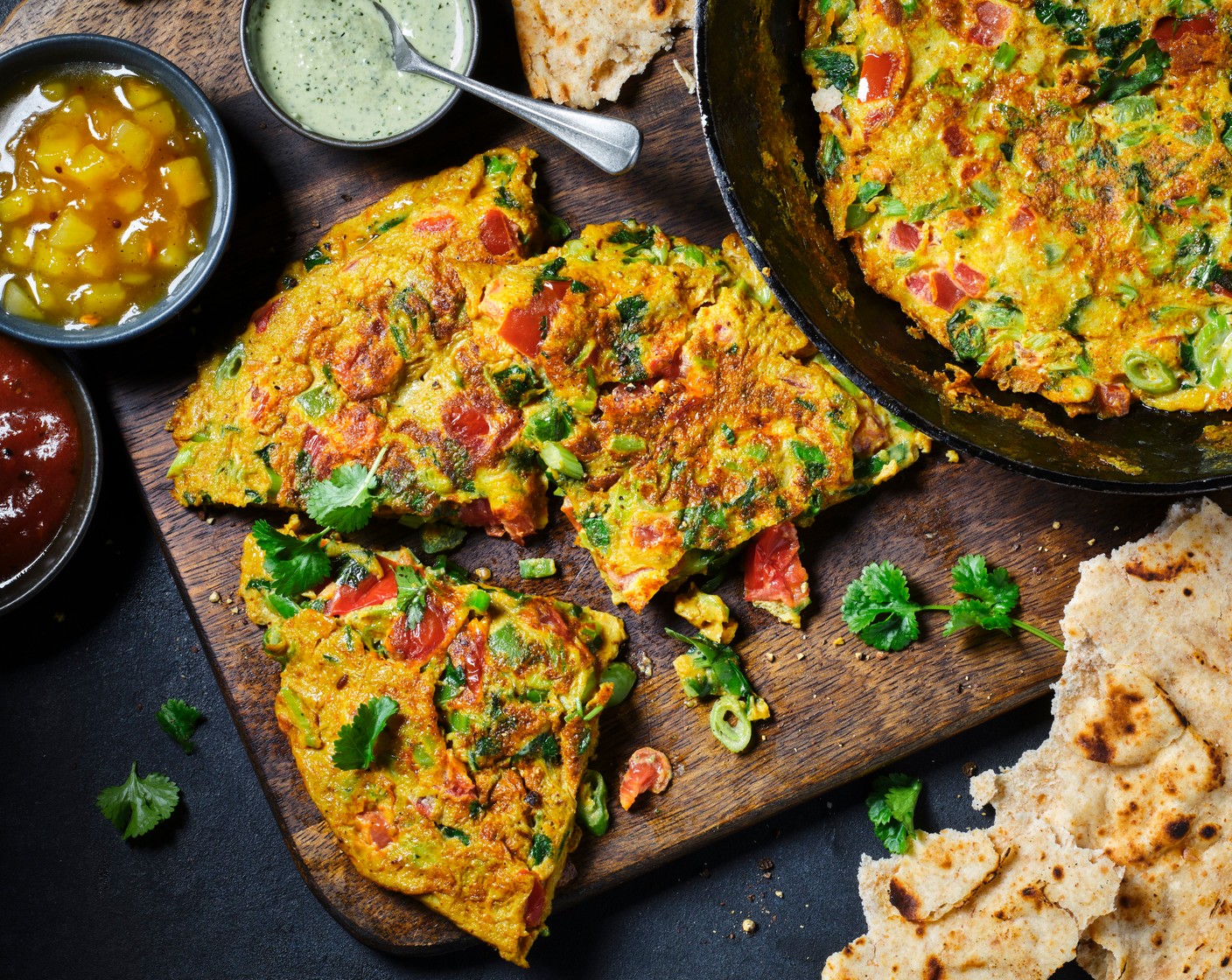 step 5 Slide the omelette onto a board and cut in half, then serve with the dips (1 pack) and roti.