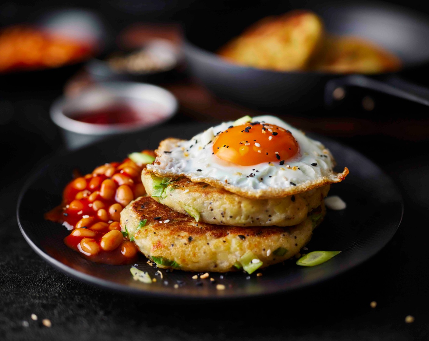 step 9 Serve the potato cakes with the beans and the fried eggs, with some extra everything seasoning sprinkled on top of the egg, if you like.