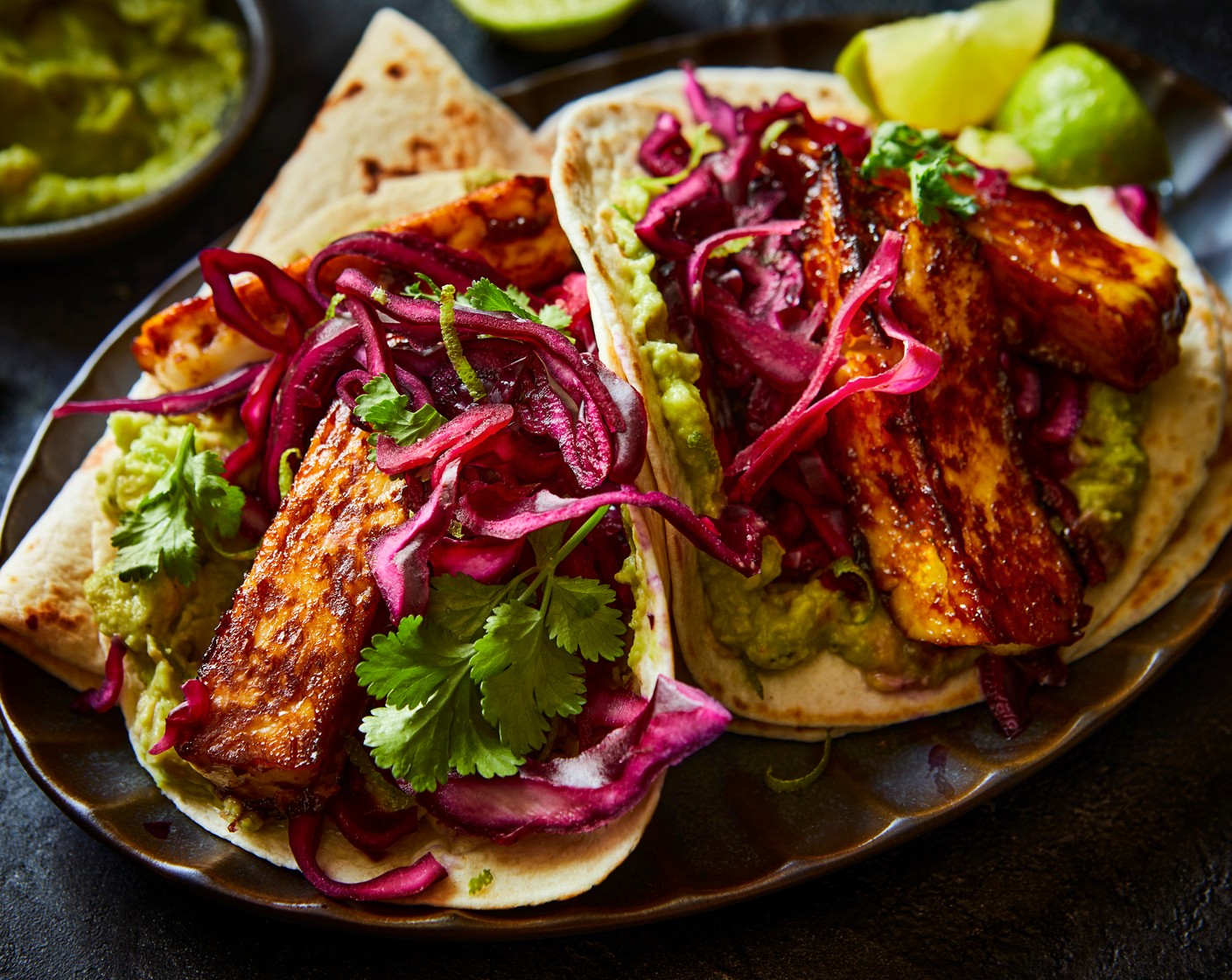step 5 Load the wraps with the hot honey halloumi, lightly pickled red cabbage, guacamole (1 pack) and a scattering of fresh coriander (10 g).