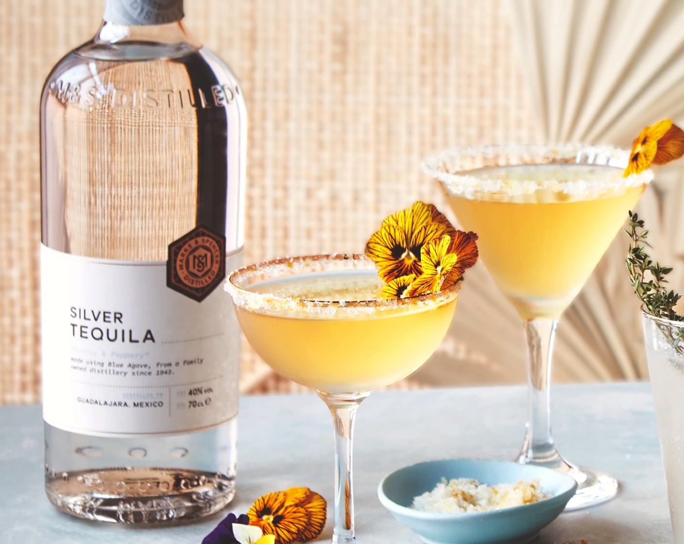 step 5 Strain into the prepared glass. Garnish with a few of the edible flowers (as needed) if using, and serve.