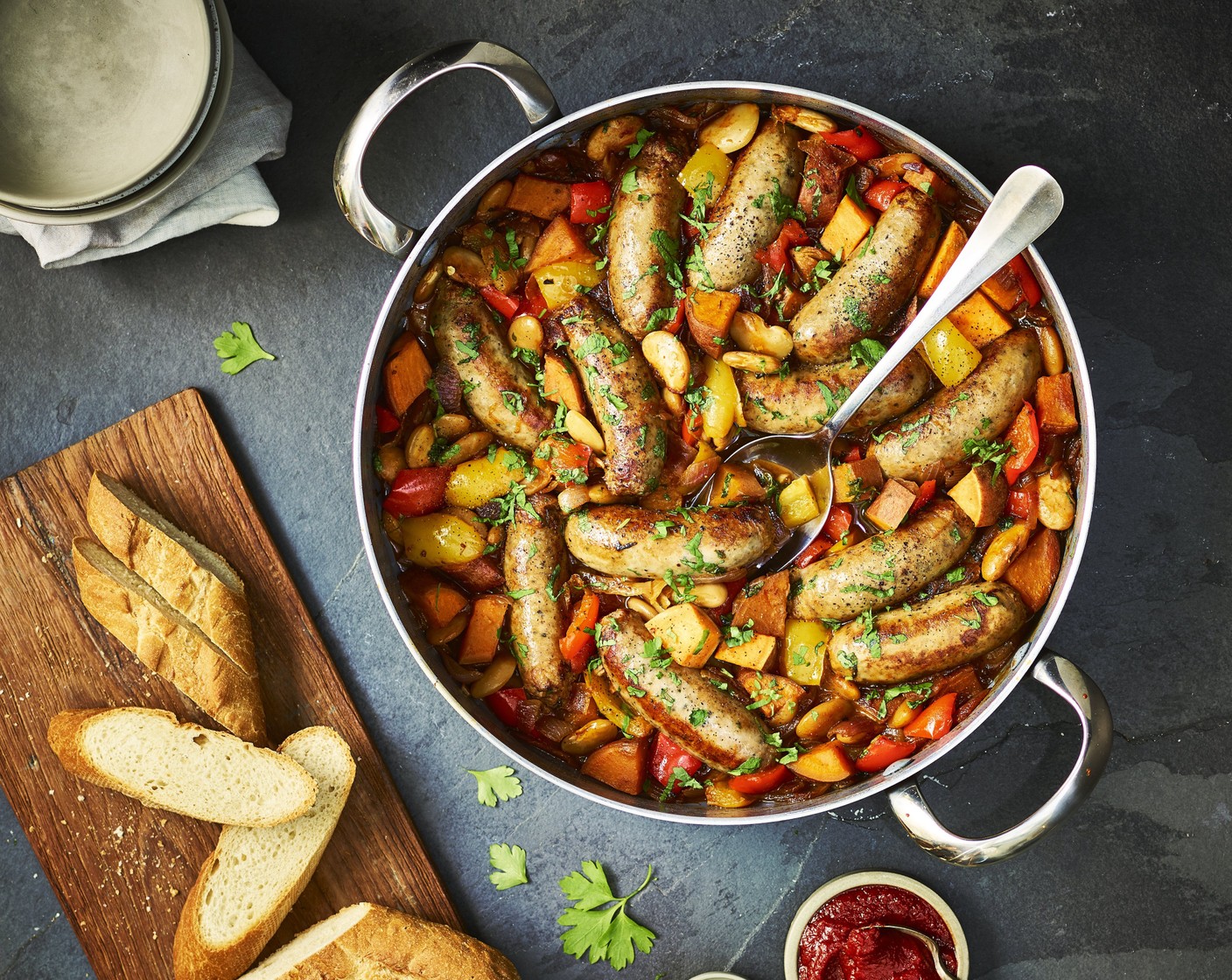 step 4 Return the browned sausages to the pan. Cover and simmer for 25 minutes. Season with salt (to taste) and black pepper (to taste) and scatter with chopped parsley (to taste) before serving with crusty bread (to taste).