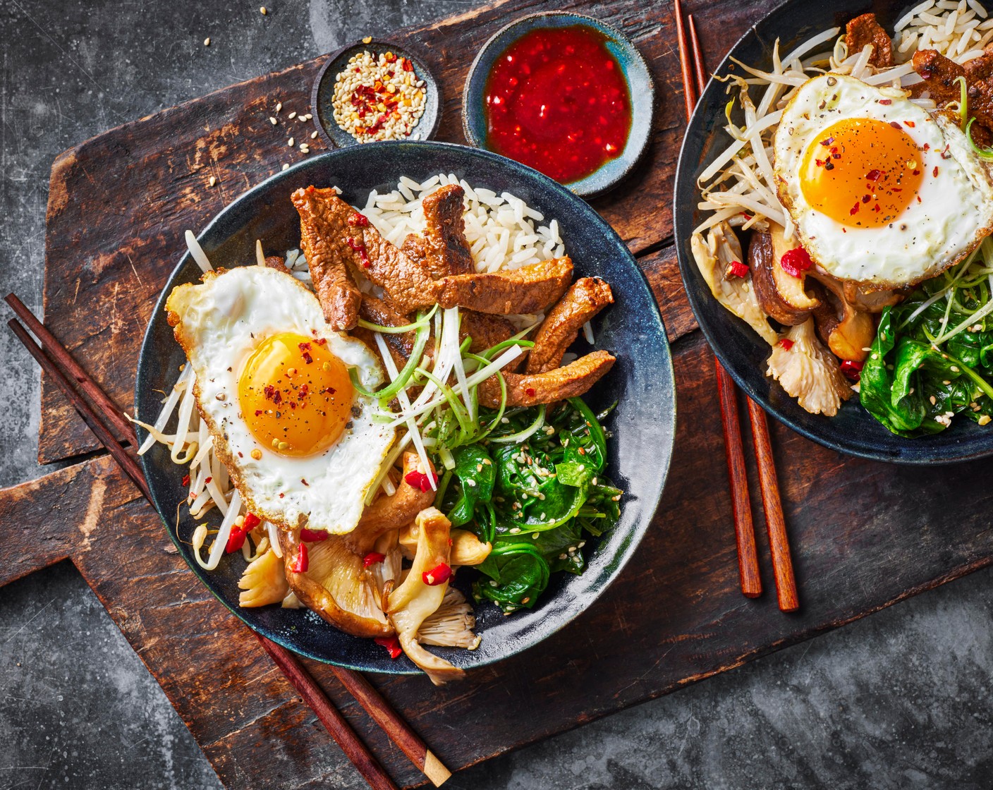 step 9 Heat remaining vegetable oil (1 tbsp) in a frying pan and fry the eggs (4) to your liking (you may have to do this in batches). Top the bowls with a fried egg and spring onions (2).