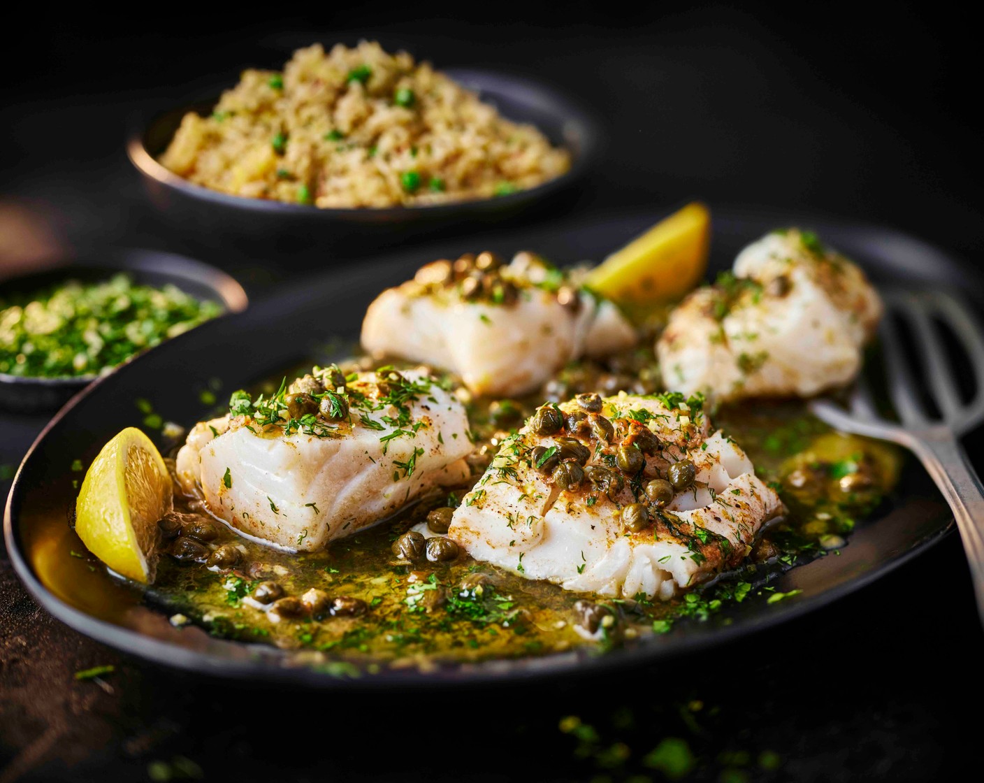 step 8 Fluff the rice with a fork, then divide between serving plates. Top with the cod, spoon over any buttery pan juices and finish with the gremolata. Serve with lemon wedges (as needed) alongside.