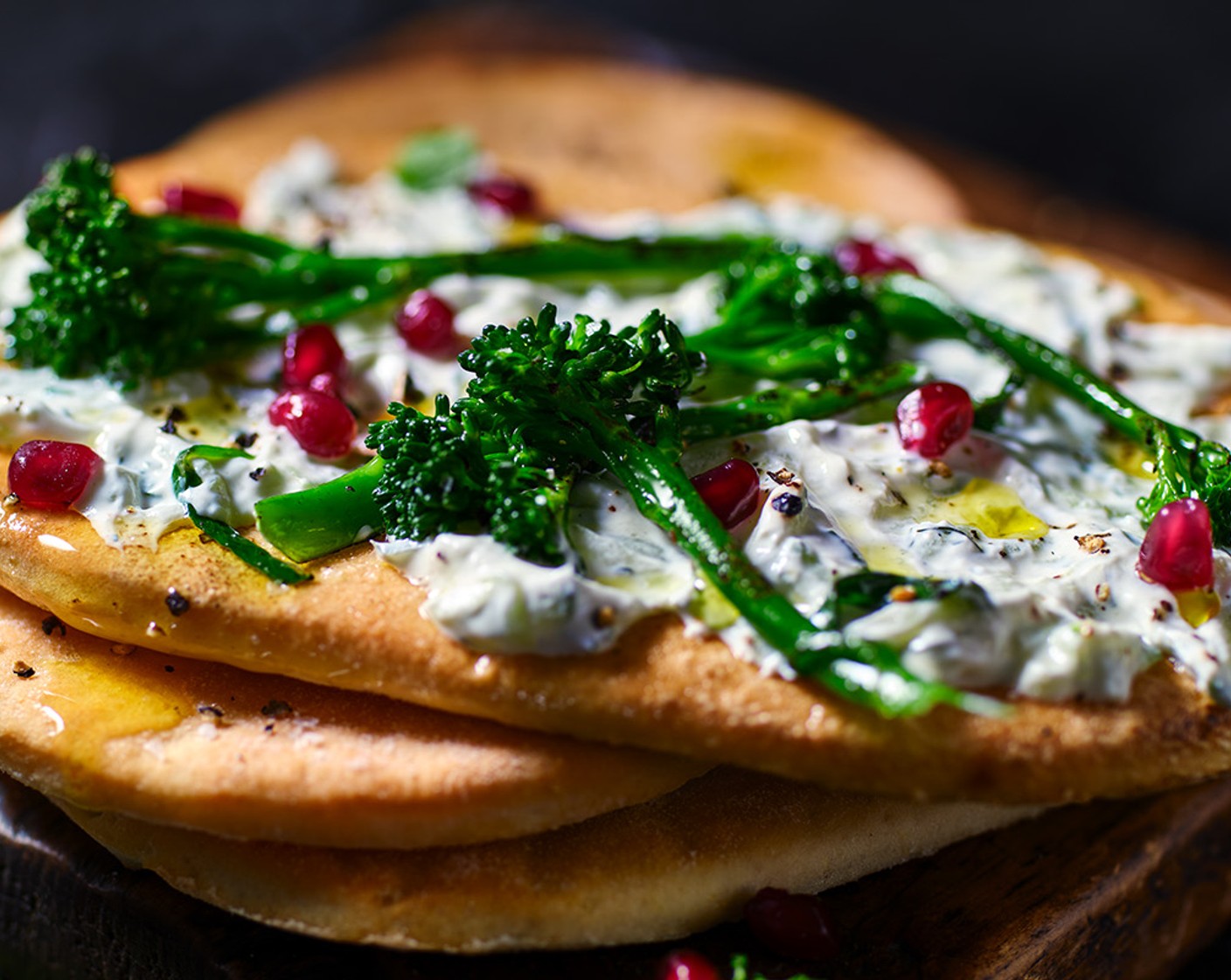 step 3 Spread each flatbread with the tzatziki (200 g) and top with the grilled Tenderstem, pomegranate (100 g) and mint (10 g). Finish with a little more seasoning.