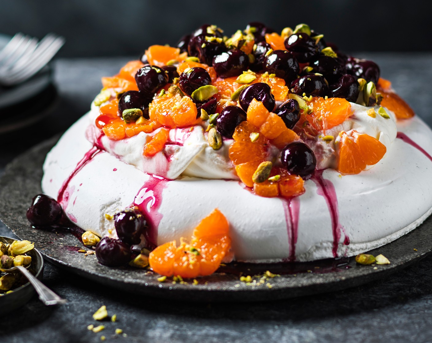 step 4 To assemble, carefully spoon the cream onto the pavlova base. Top with the clementines and spoon over the cherries in kirsch (4 tbsp), as well as some of the liquid from the jar. Finish by scattering over the pistachios (2 tbsp).