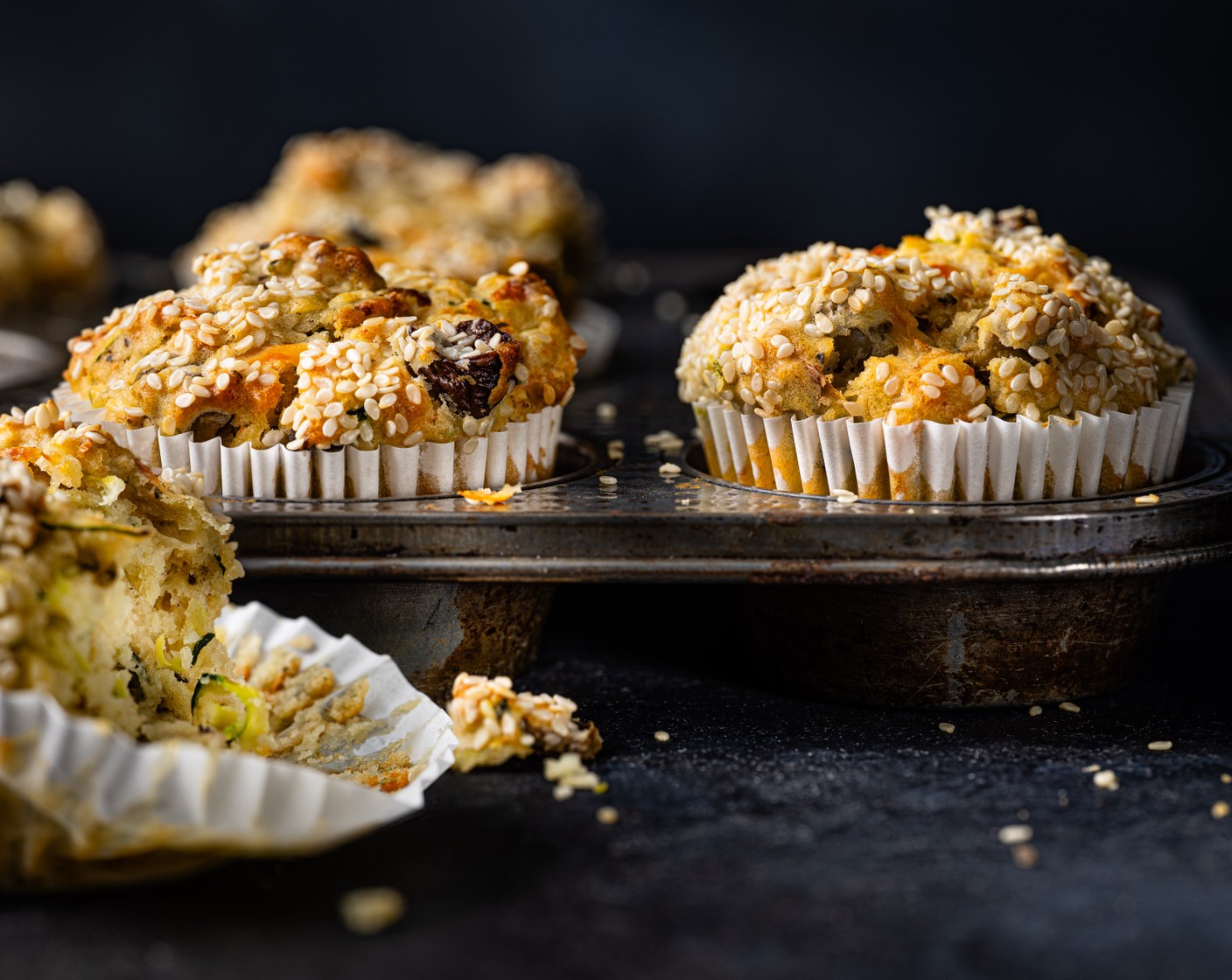 step 3 Line a muffin tray with 6 large compartments with greaseproof paper or muffin cases. Equally divide the batter between them and sprinkle with the sesame seeds (1 tbsp). Bake for 20-25 minutes, until the tops are golden and a skewer comes out clean.
