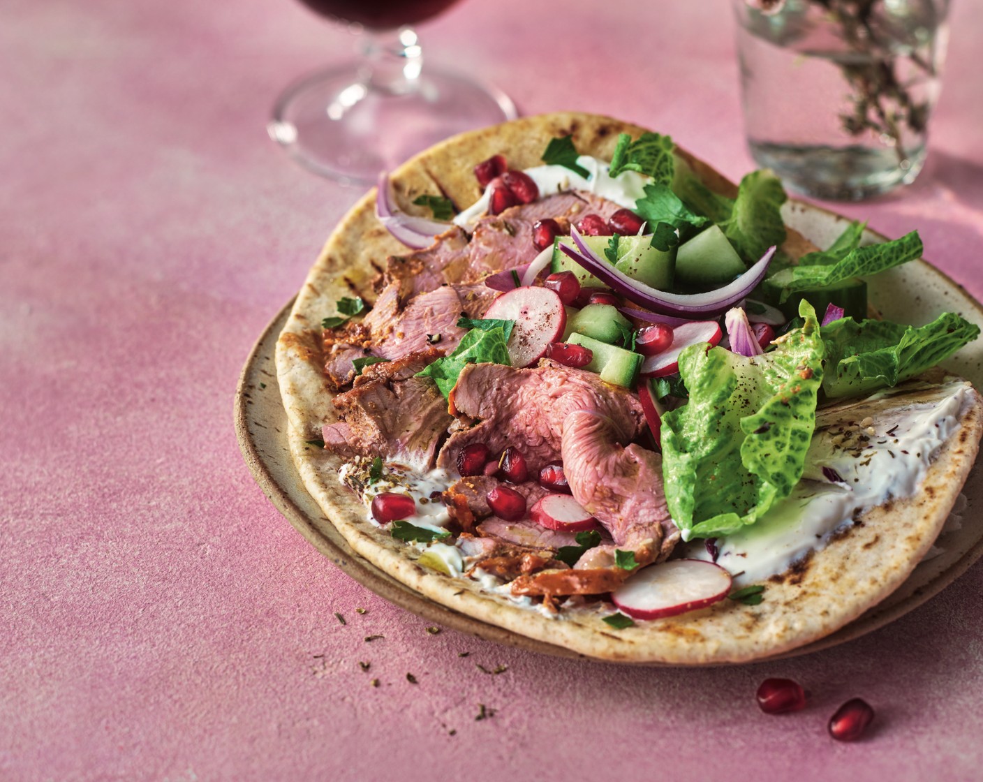 step 4 Mix the yogurt (200 g) with the garlic (1 clove) and sprinkle with the za’atar (to taste). Once the lamb has rested, carve into thin slices and serve with the salad, yogurt and flatbreads (6).