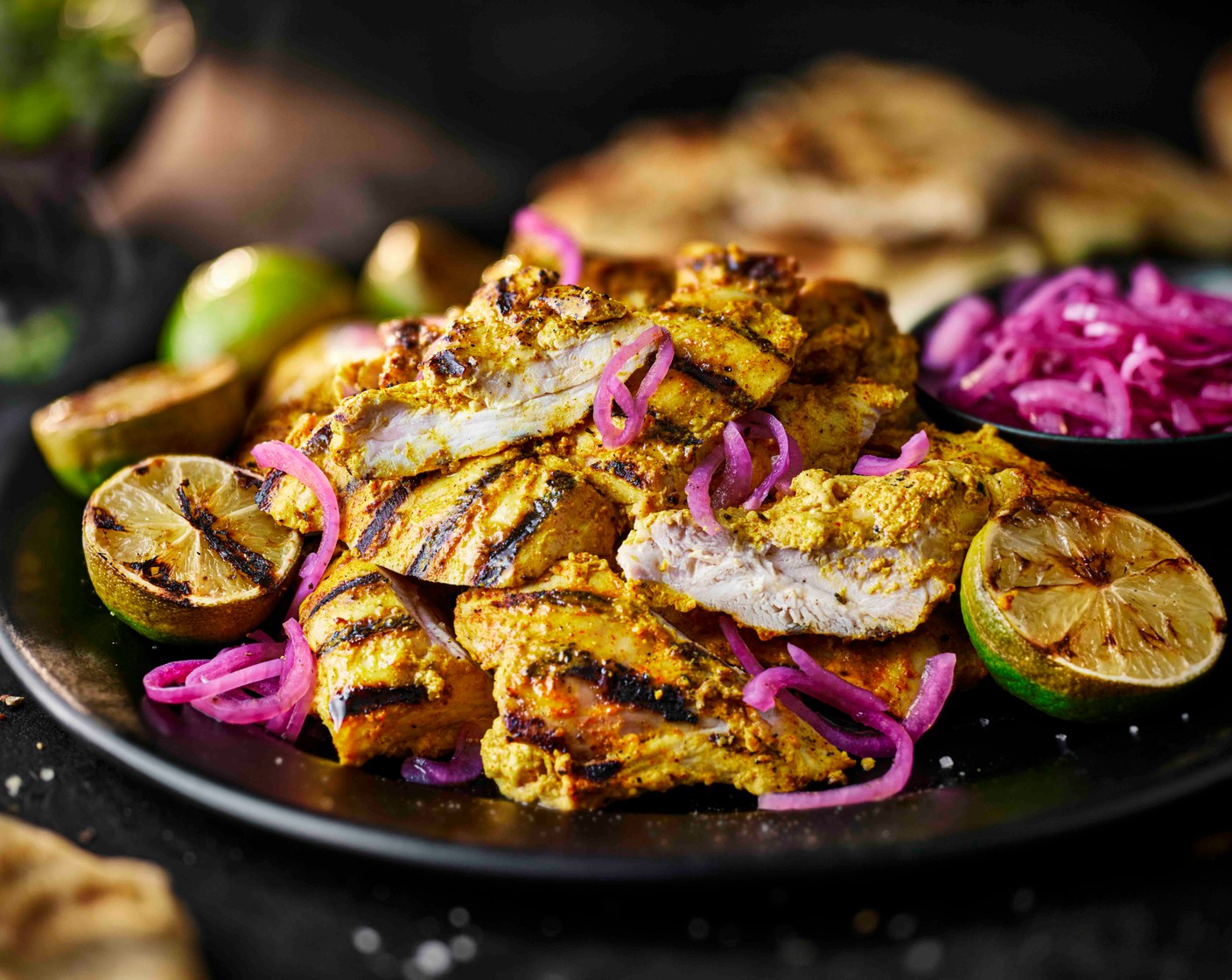 step 6 Add the cooked chicken to a large serving platter, alongside the flatbreads (2 packs), pickled onions (1 pack) and grilled limes.