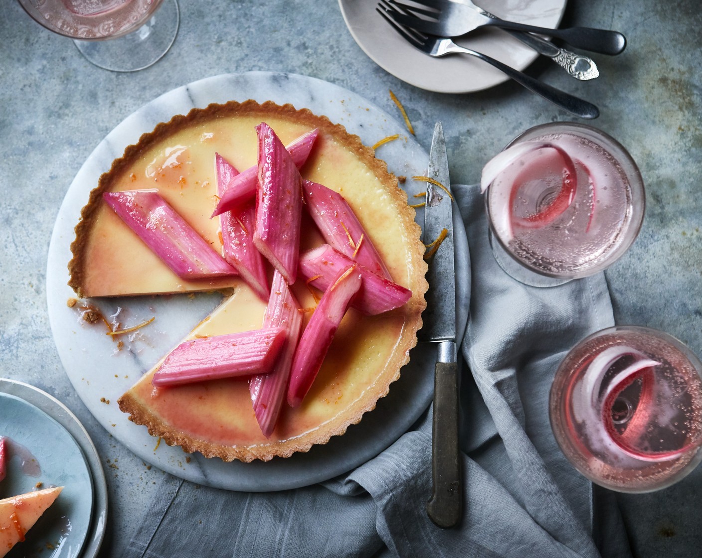 step 6 Remove the tart from the oven and top with the rhubarb, the cooking syrup, and some extra orange zest.