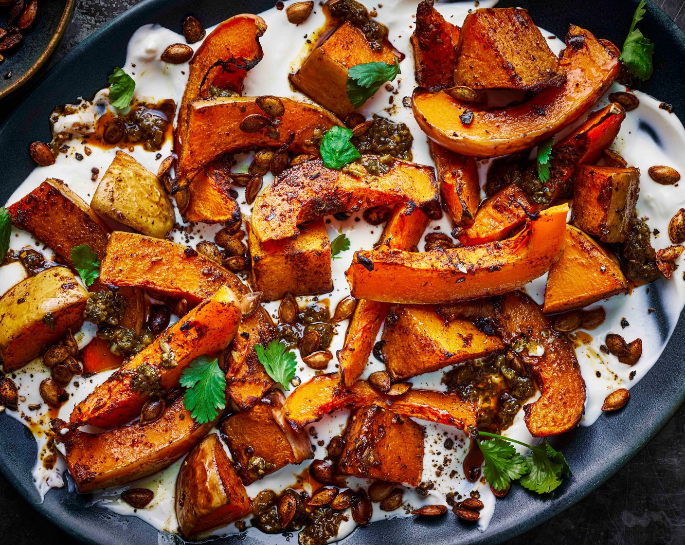 step 3 Spread the yogurt sauce onto a platter and arrange the squash slices on top. Spoon over the chimichurri (2 tbsp). Optional: scatter over the roasted squash seeds.