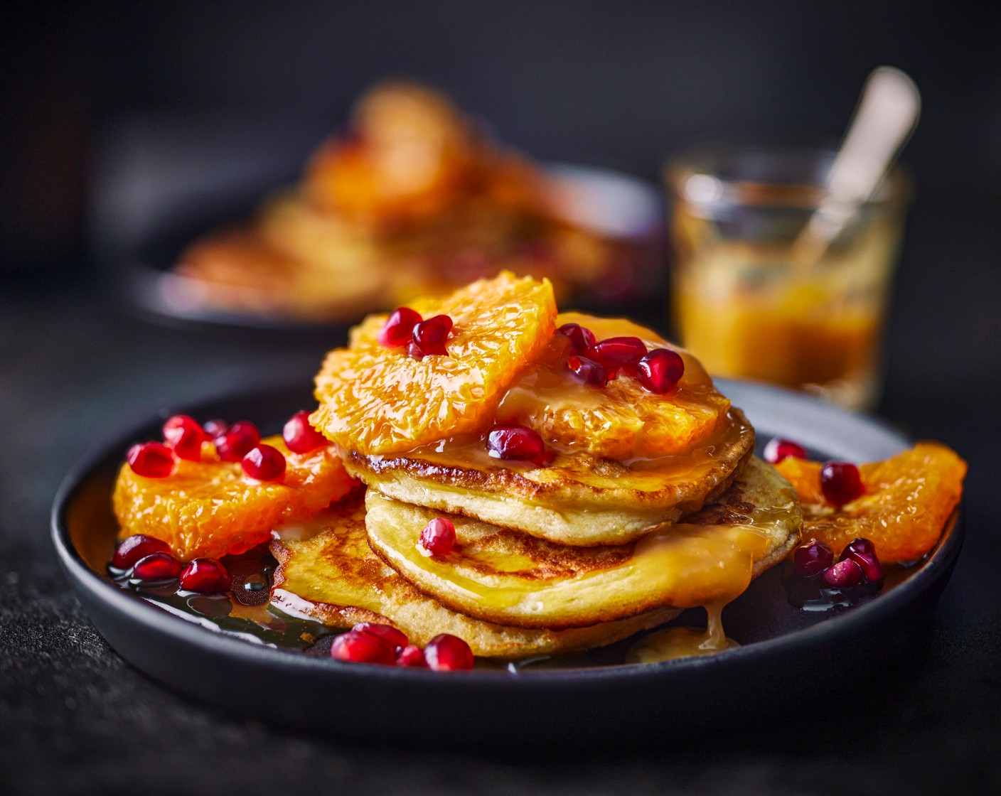 step 8 Serve the hotcakes on four plates, with the clementines, a scattering of pomegranate rubies (4 tbsp), and a dollop of salted caramel sauce.