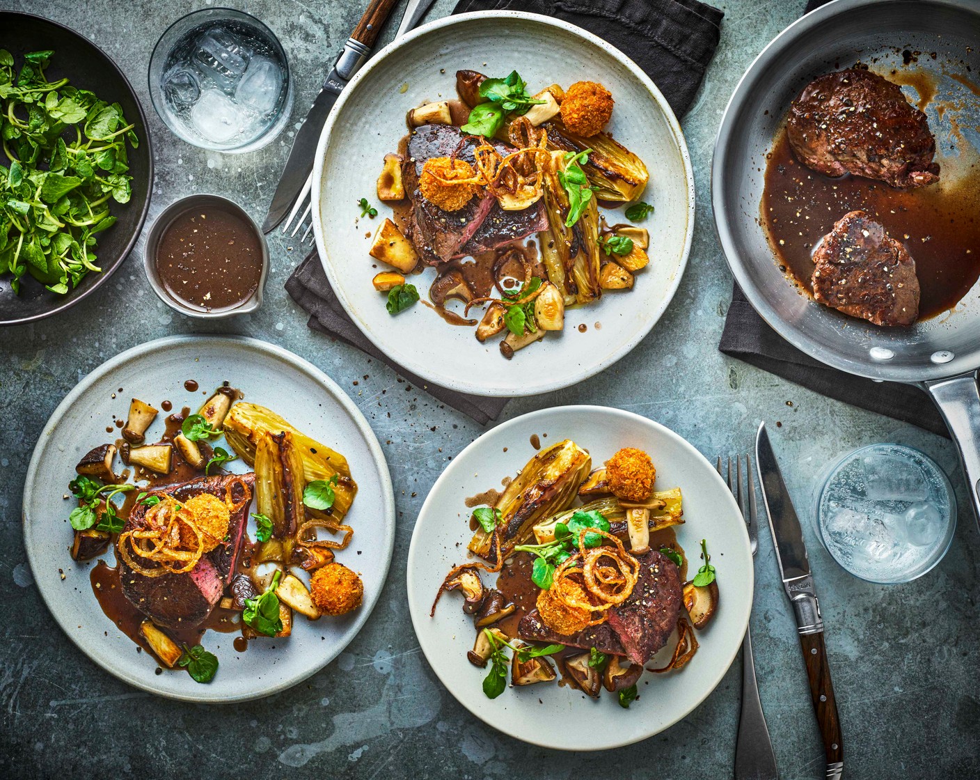 step 8 Serve the steaks with the fennel, wild mushrooms, and bonbons. Add a little of the sauce to each plate and serve the rest in a jug. Finish with a garnish of watercress (100 g).