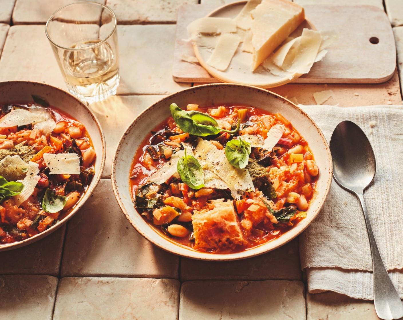 step 3 Ladle into four bowls and allow to cool a little – the soup is best enjoyed warm, rather than hot. Finish each bowl with a spoonful of pesto (1 tbsp), a scattering of basil (1 handful), some parmesan shavings (20 g) and a drizzle of olive oil.