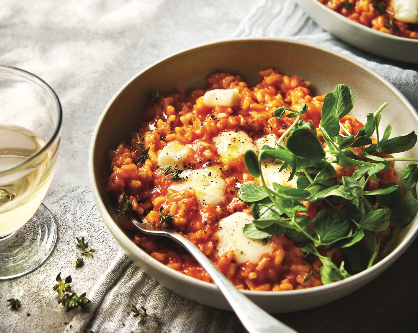 step 5 Keep adding the stock mix until the rice is cooked al dente, then stir in most of the taleggio (200 g). Serve the risotto topped with pea shoots (to taste), the remaining taleggio and a drizzle of olive oil.