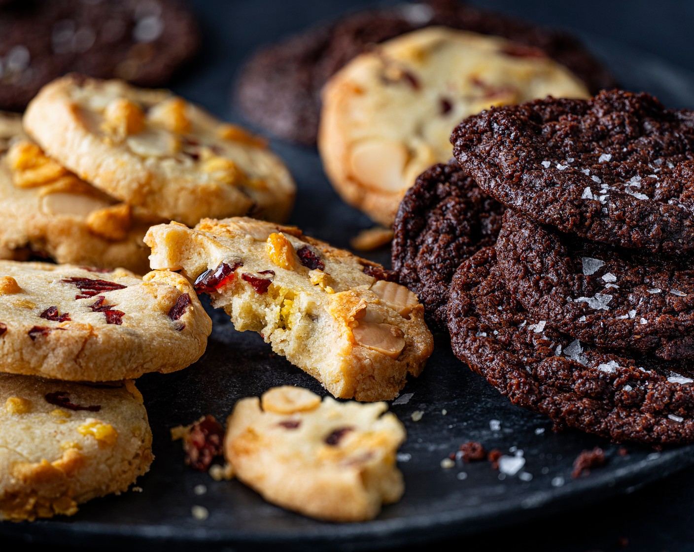 step 10 When you’re ready to bake, preheat the oven to 180°C/160°C fan/gas mark 4. Slice the log into 14 and flatten each round. Spread out over a couple of lined baking trays. Bake for 12-14 minutes, until the edges are crisp and the tops are no longer oily looking.