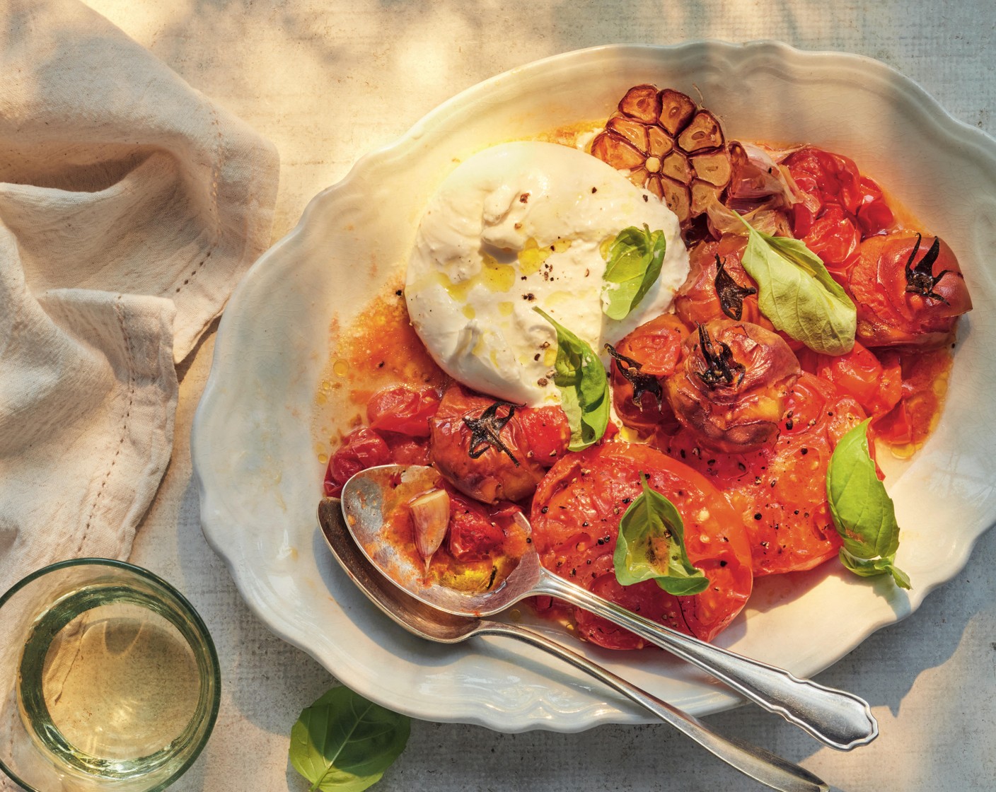 step 2 Spoon the tomatoes onto a large sharing plate, top with the torn mozzarella (2 pieces) or burrata, the basil (1 handful) and a drizzle of olive oil. Serve with focaccia (1 loaf) or crusty bread to mop up the juices.