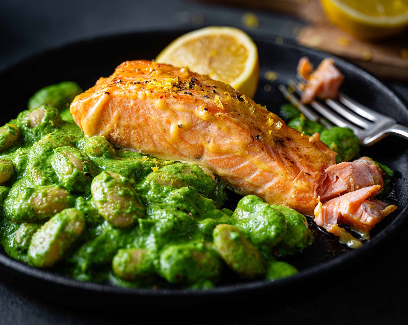 step 7 Add the mix back to the pan and add in one jar of beans (2 jars) with their liquid. Drain and rinse the other jar of beans and add it to the pan. Simmer the beans together for 5 minutes, until warmed through. Serve the butter beans in bowls topped with the baked salmon and the remaining lemon (1/2) cut into wedges.