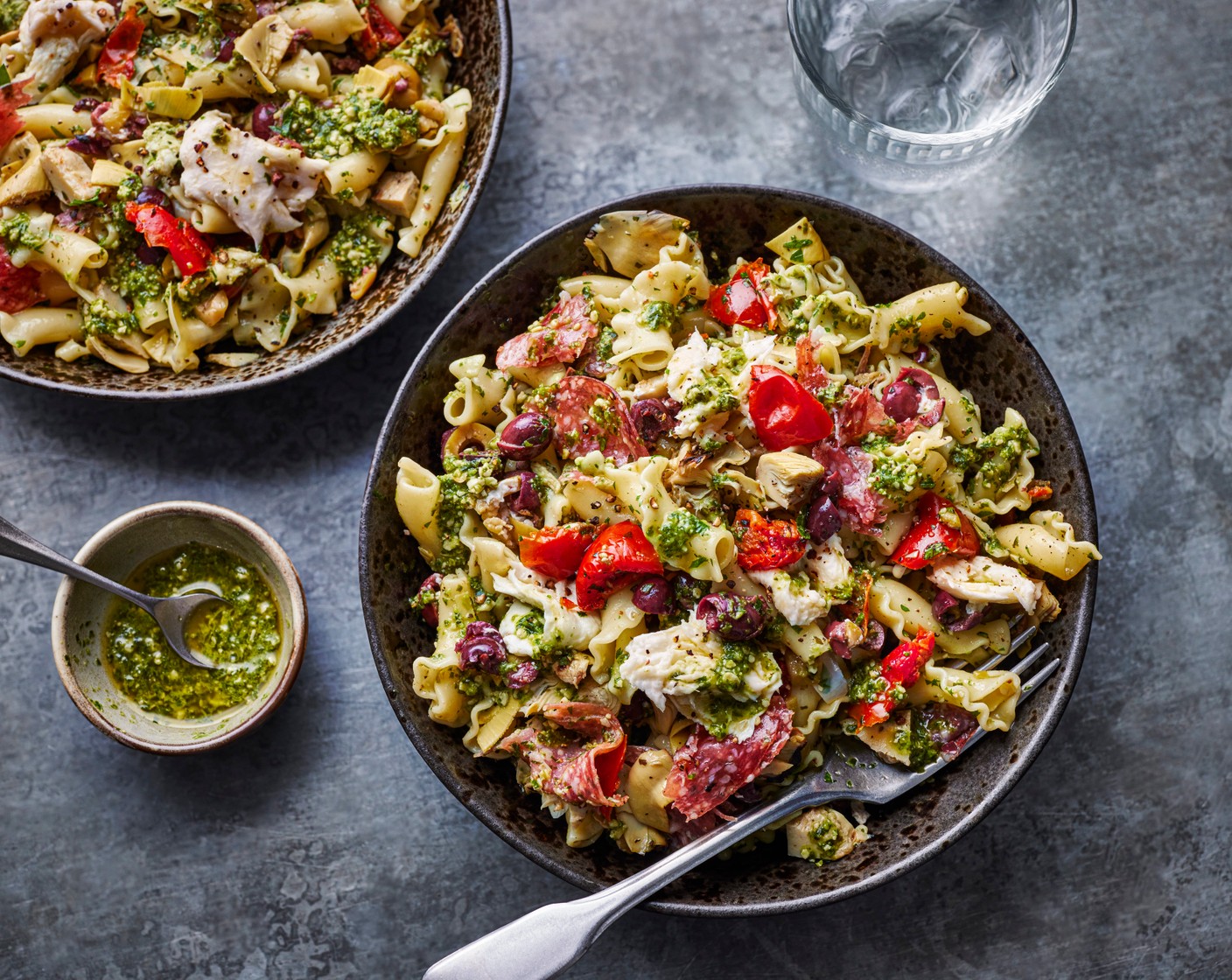 step 2 In a large bowl, combine the mozzarella (1 pack), dried tomatoes (1 tub), olives (1 tub), artichokes (1 tub), salami (45 g), green pesto (2 tbsp) and parsley (2 tbsp) (including any oil from the antipasti packets) with a splash of cooking water to combine. Toss through the cooked pasta and serve.
