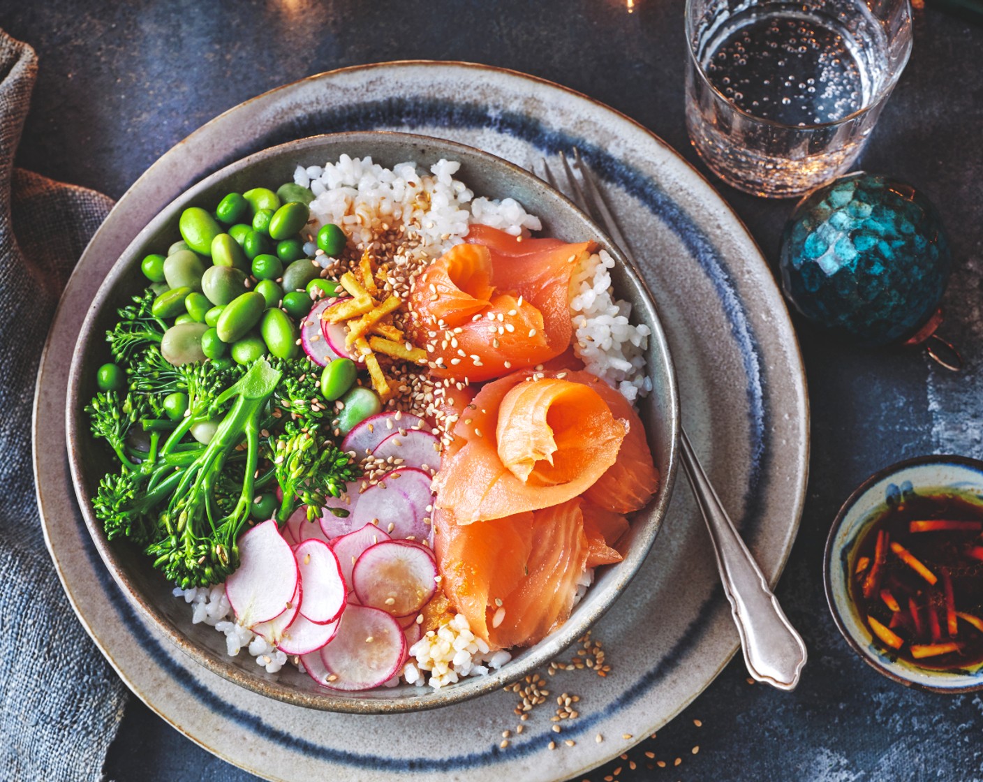 step 4 To build the bowls, top the sushi rice with the broccoli and bean and pea mix, then add the radishes (1 handful) and Collection Scottish mild and delicate smoked salmon (1 pack). Scatter with the toasted sesame seeds and serve with the soy and ginger dressing.