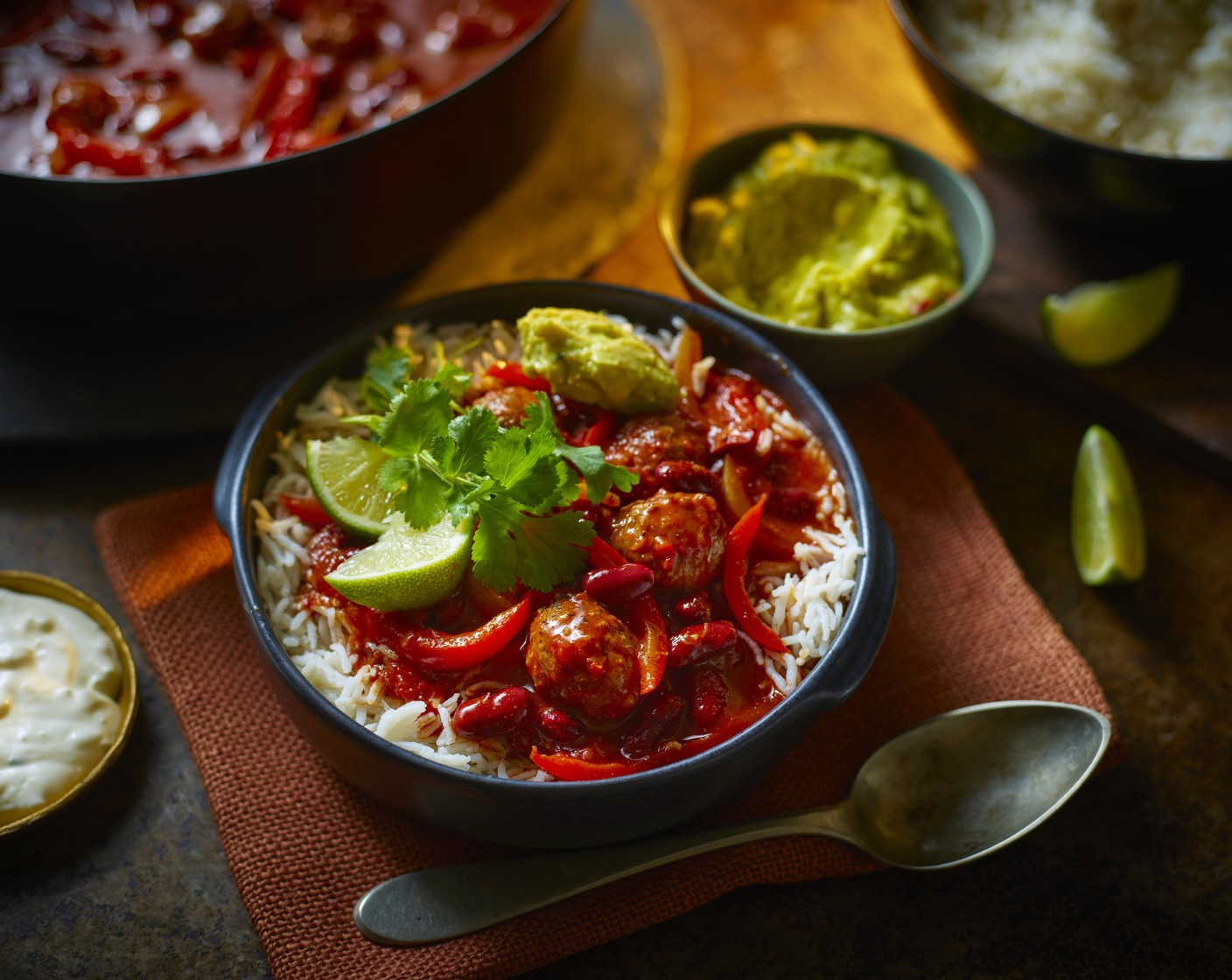 step 4 Serve in a large bowl and let people help themselves, along with the wholegrain rice (2 packs), guacamole (to taste) and M&S zingy onion and garlic dip (to taste). Garnish with lime wedges (1) and chopped coriander (to taste).