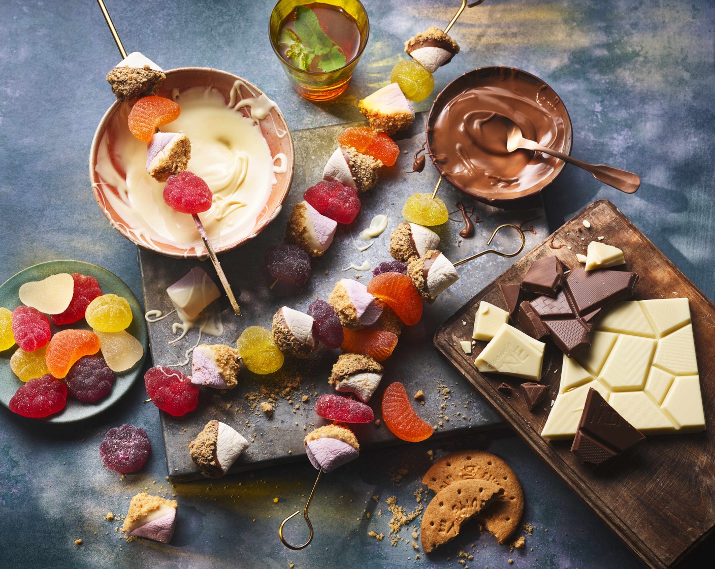 step 3 Once set, assemble the kebabs by adding the marshmallows and M&S fruit jellies (1 pack) onto the skewers.