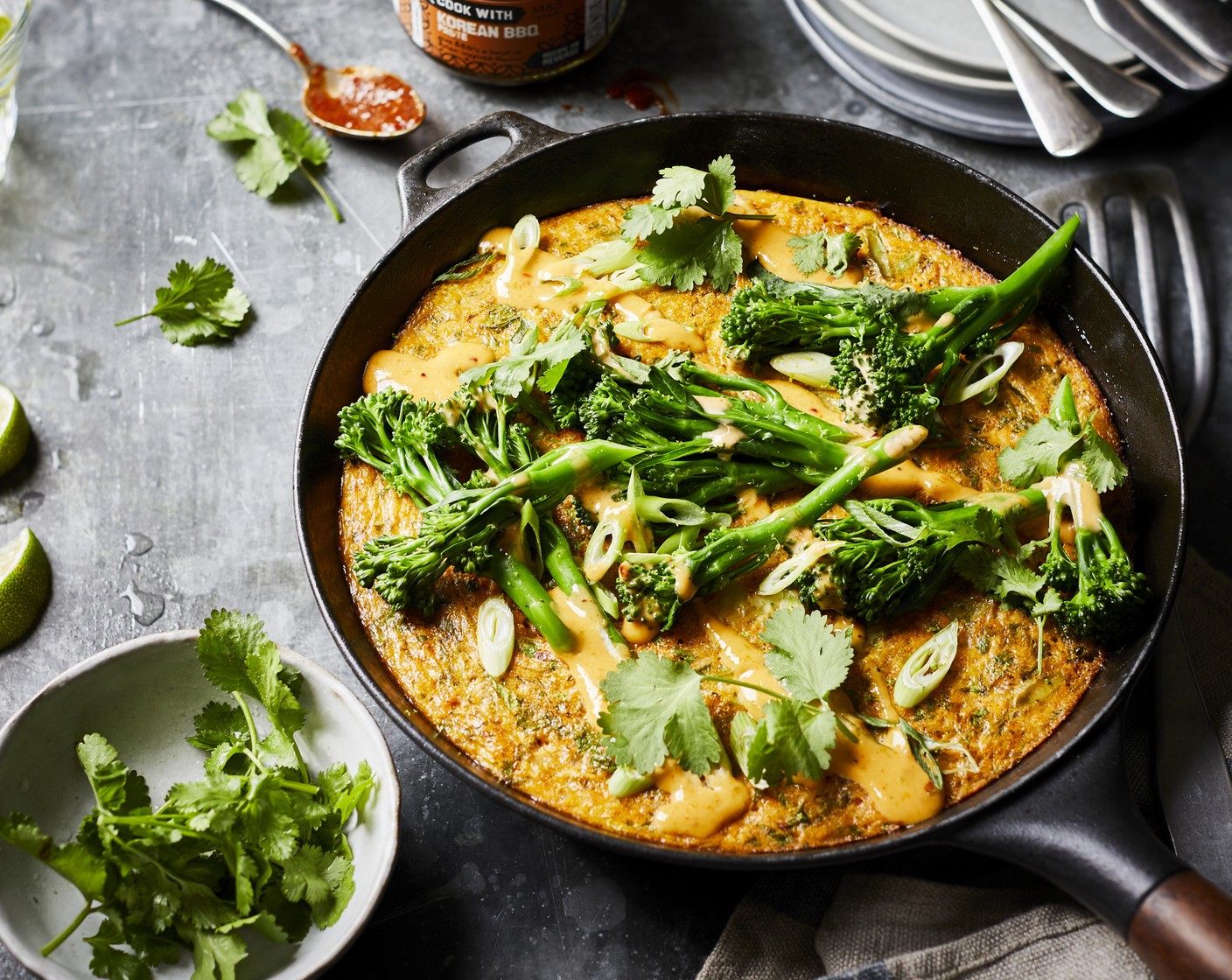step 8 Turn the cooked omelette on to a plate and top with the warm Tenderstem tips, drizzle with the zesty mayo and garnish with remaining fresh coriander and spring onion. Cut into slices and serve.