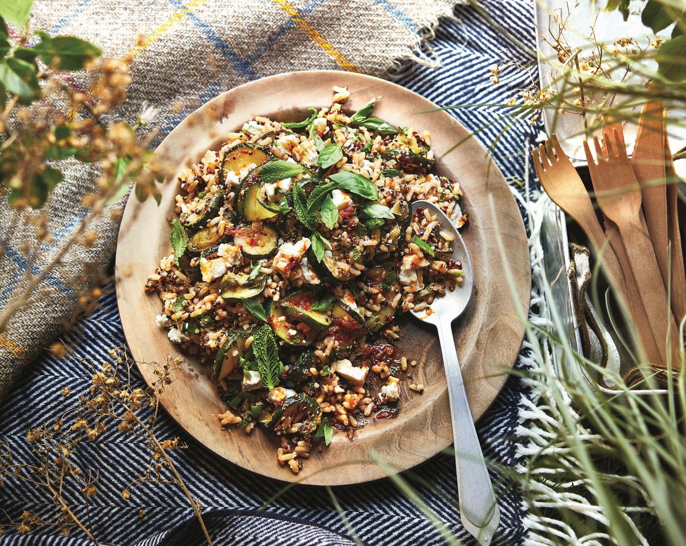 step 3 Stir half of the dressing through the grains (2 pouches) and pile on to a platter or into a container. Serve topped with the courgettes, crumbled feta (100 g), mint (10 g), basil (10 g) and the remaining dressing.