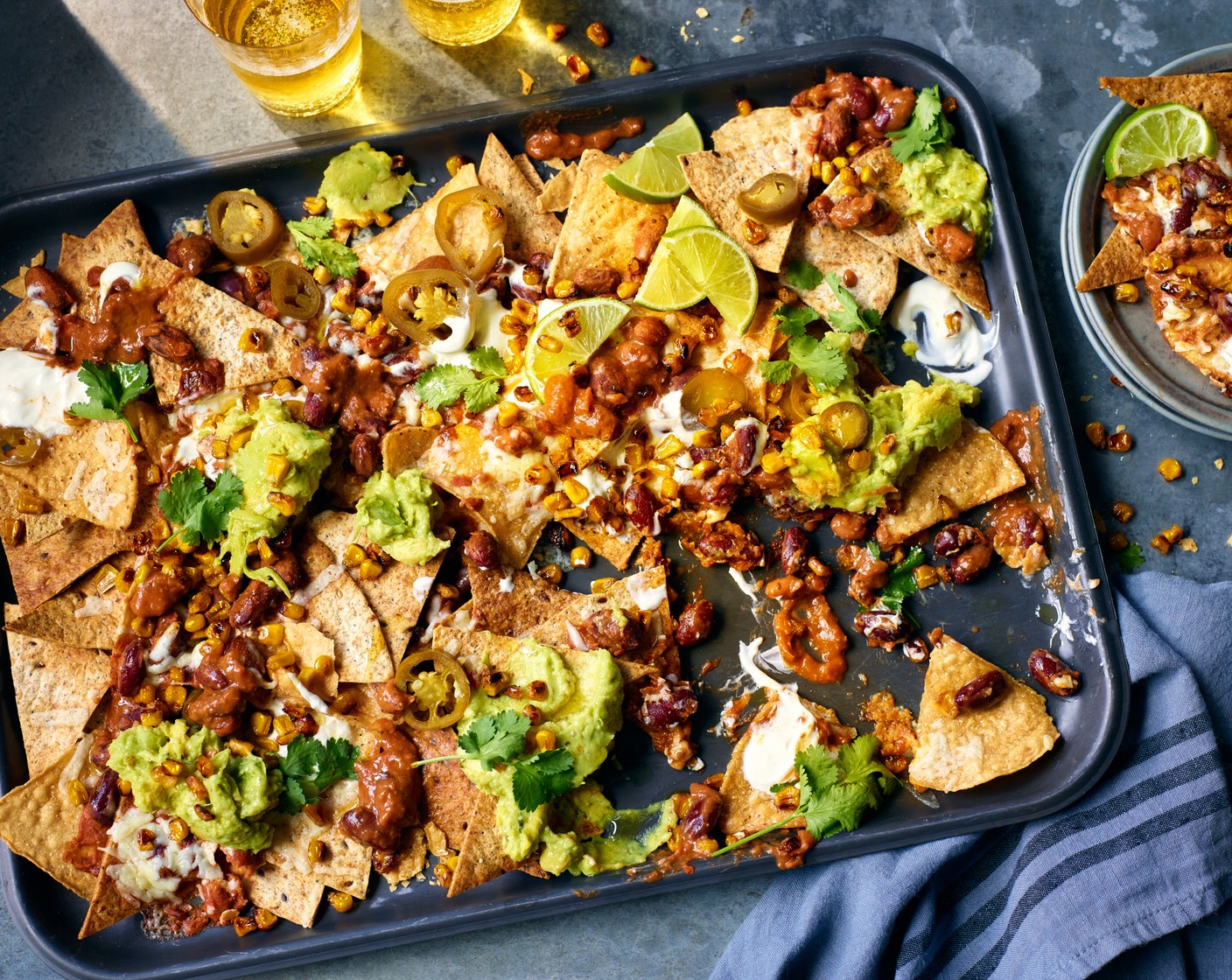 step 5 Scatter over the M&S sliced green pickled jalapeño (1 tbsp) and spoon the M&S zesty guacamole dip (170 g) on top, then finish with a scattering of fresh coriander (1 handful). Serve with lime (1) wedges.
