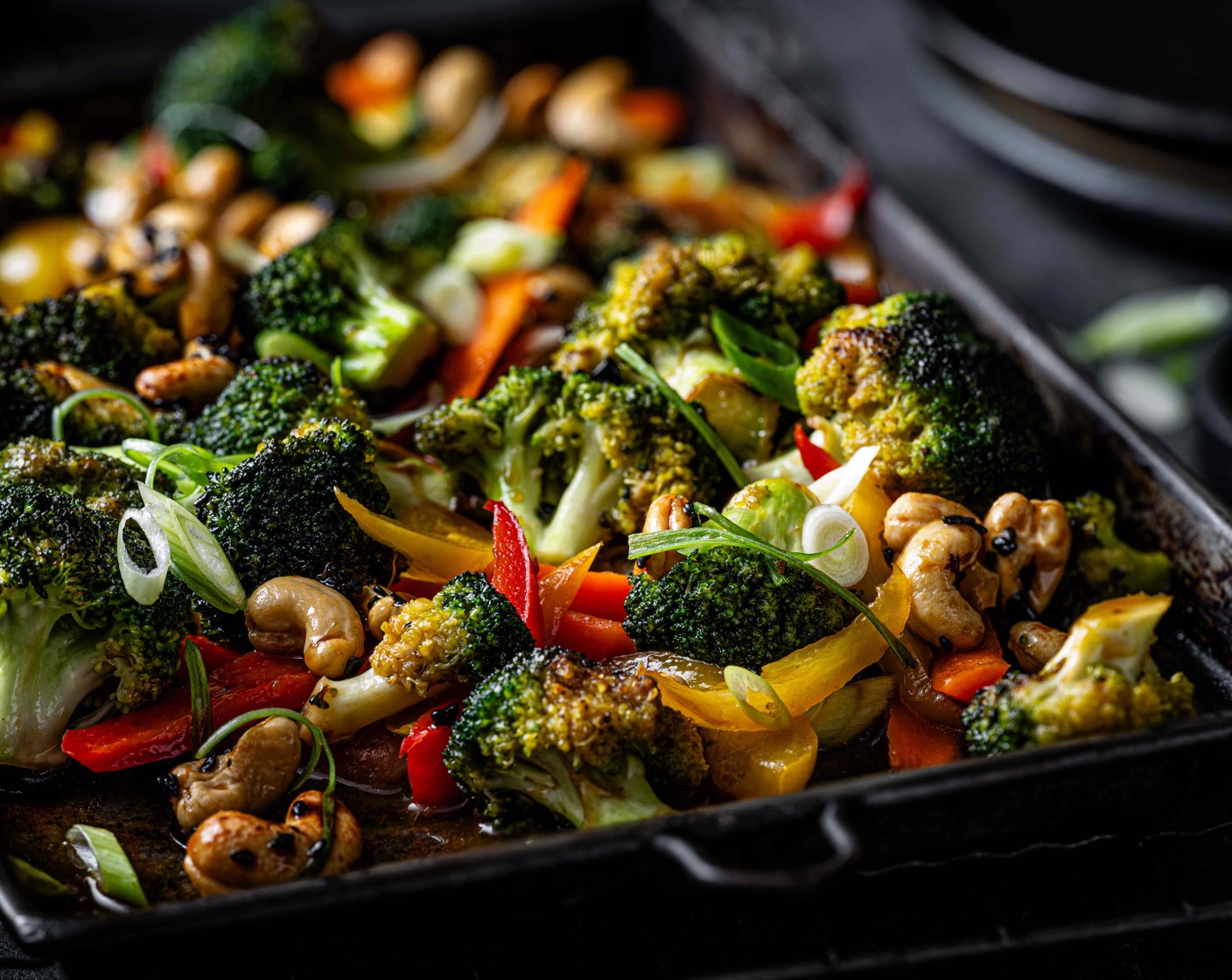 step 6 Serve the sticky veggies with the rice and top with the thinly sliced spring onions (2) and crunchy cashew mix.
