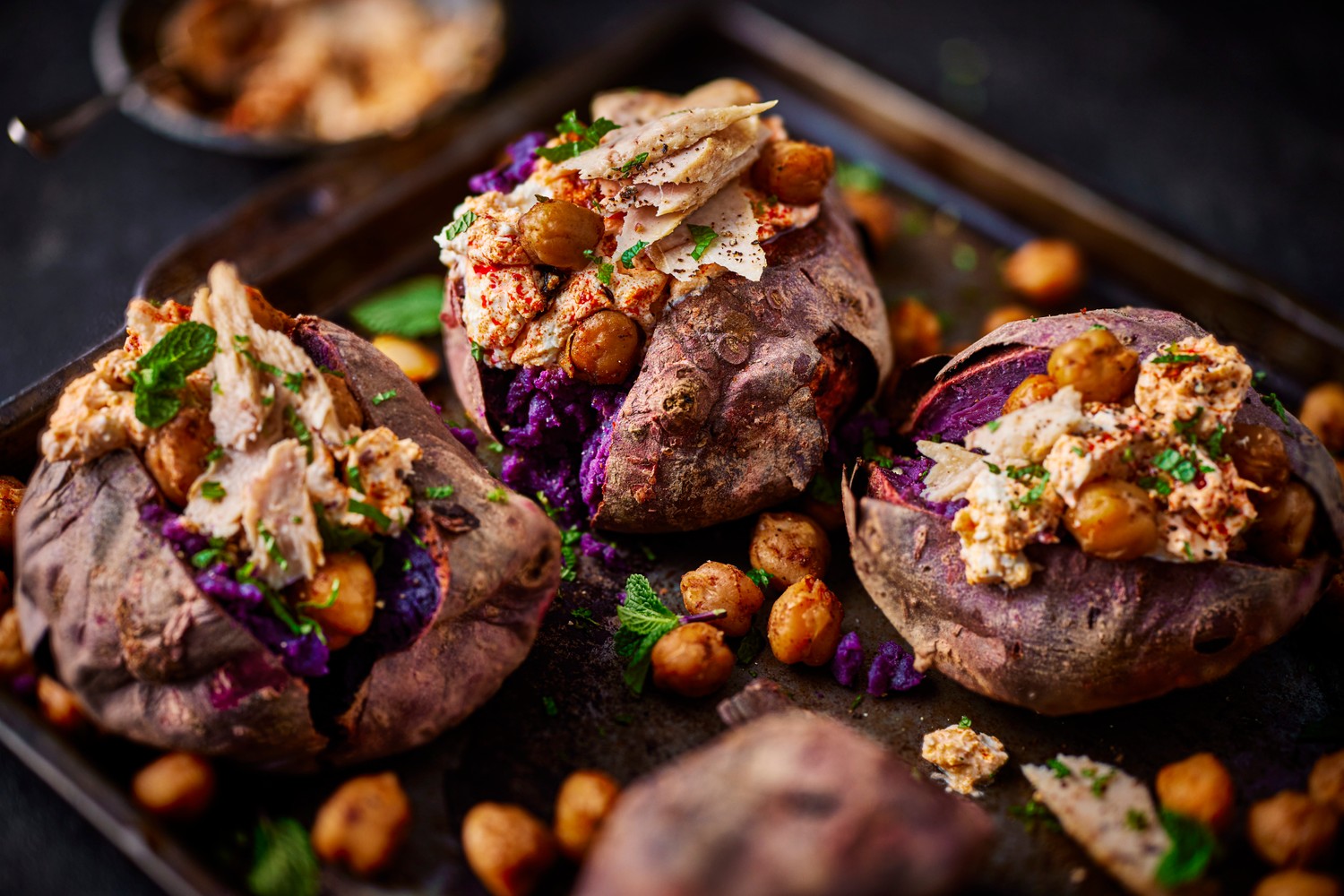 Roasted purple sweet potatoes with tuna, whipped harissa cottage cheese and crispy chickpeas