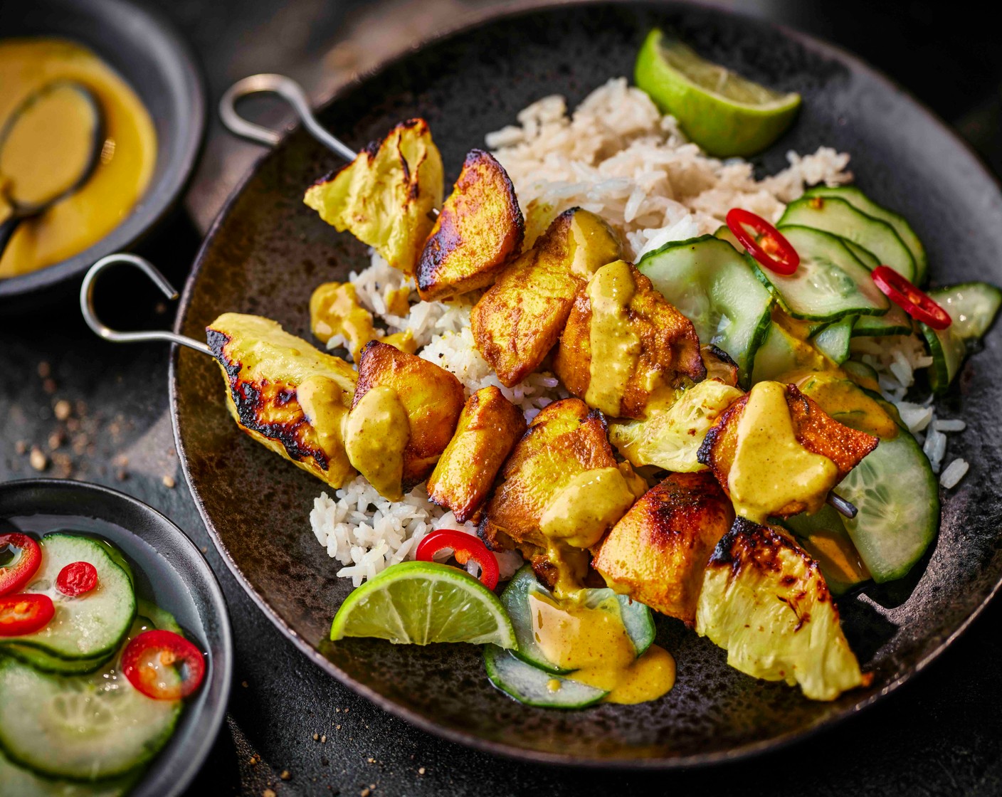 step 6 Serve the rice with the chicken and pineapple, the cucumber and the satay sauce drizzled over.