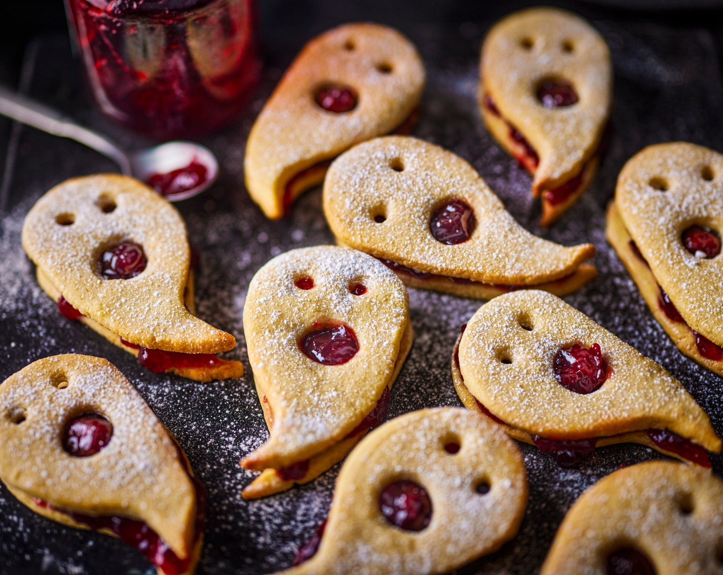 step 10 Once cool, lay the uncut biscuits out on a lined plate or tray. Top with the morello cherry conserve (12 tsp) and sandwich the cutout ghosts on top.