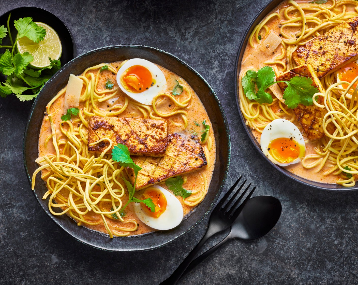 step 10 Gently reheat the curry sauce, then add the boiled noodles to a bowl, and top with the sauce. Add the tofu, fried noodles, bamboo shoots (1 tin), coriander (as needed), lime wedges (as needed) and finish with the egg.