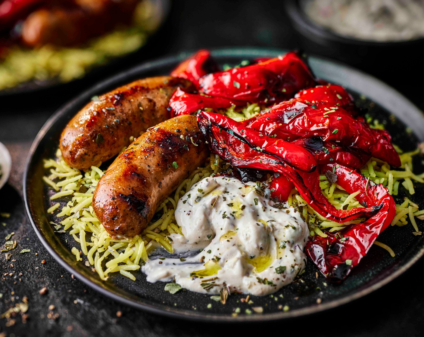 step 3 Spoon the rice into four plates and top with the sausages and peppers. Serve with a dollop of Greek-style dip (1 tub) on the side and a sprinkling of dried oregano.